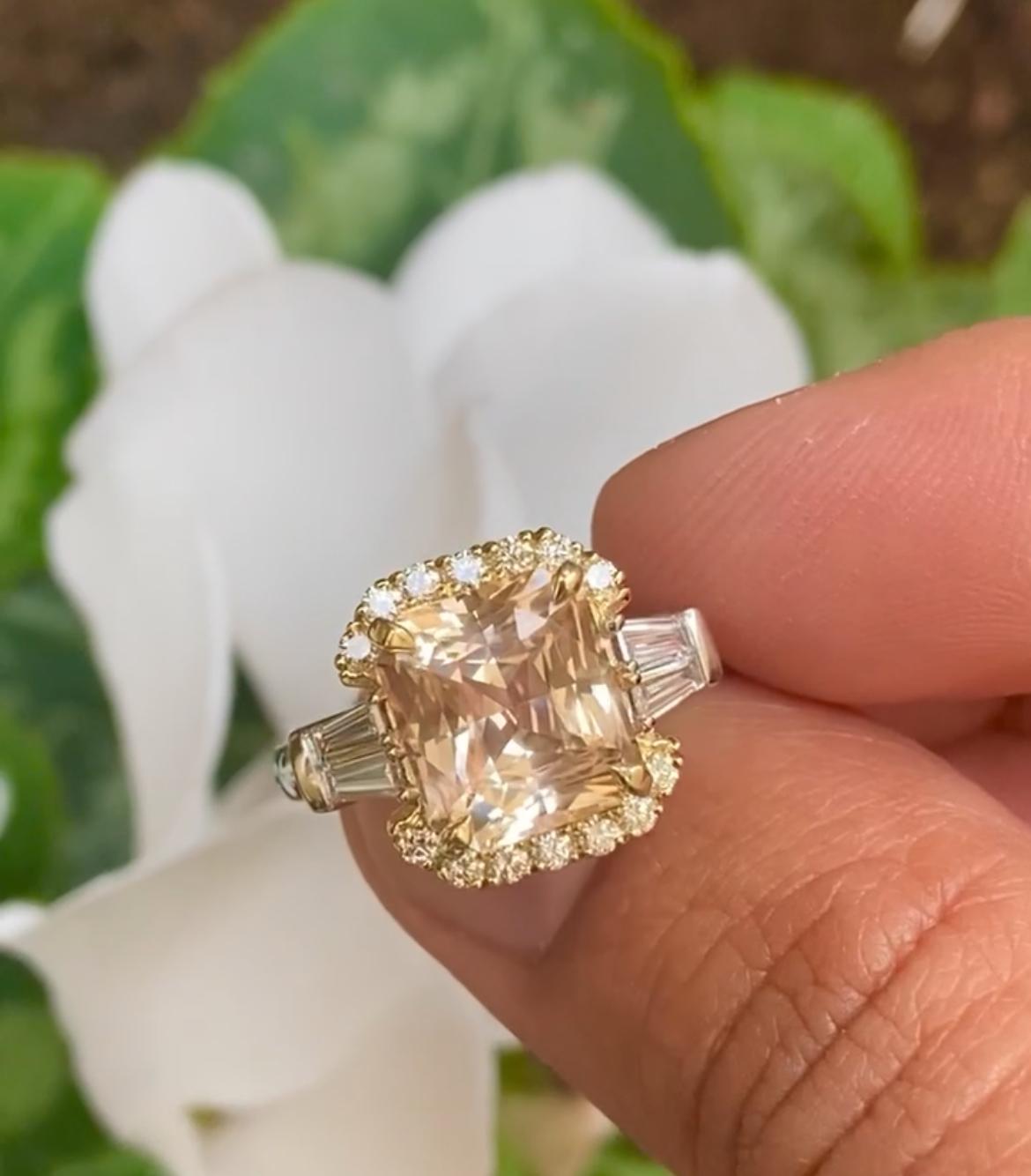 The unique color of this peach sapphire is perfectly showcased in this striking platinum ring. 

Featuring an untreated 6.02-carat, peachy-apricot Sapphire from Sri Lanka, supported by tapered-baguette diamonds totaling 0.41ct and round