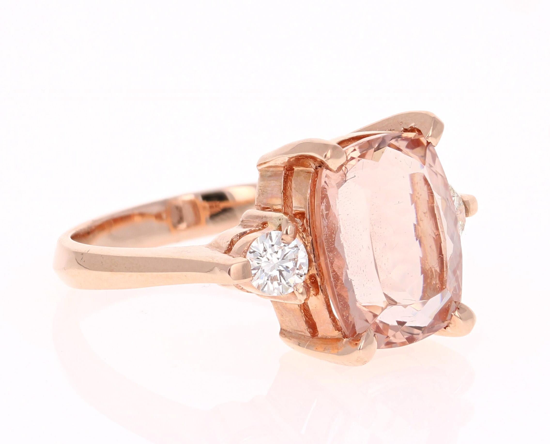 A lovely Engagement Ring Option! This simple yet gorgeous Morganite Ring has a 5.63 Carat Cushion Cut Morganite as its center and has 2 Round Cut Diamonds that weigh 0.40 carats. The total carat weight of the ring is 6.03 carats.
It is set in 14