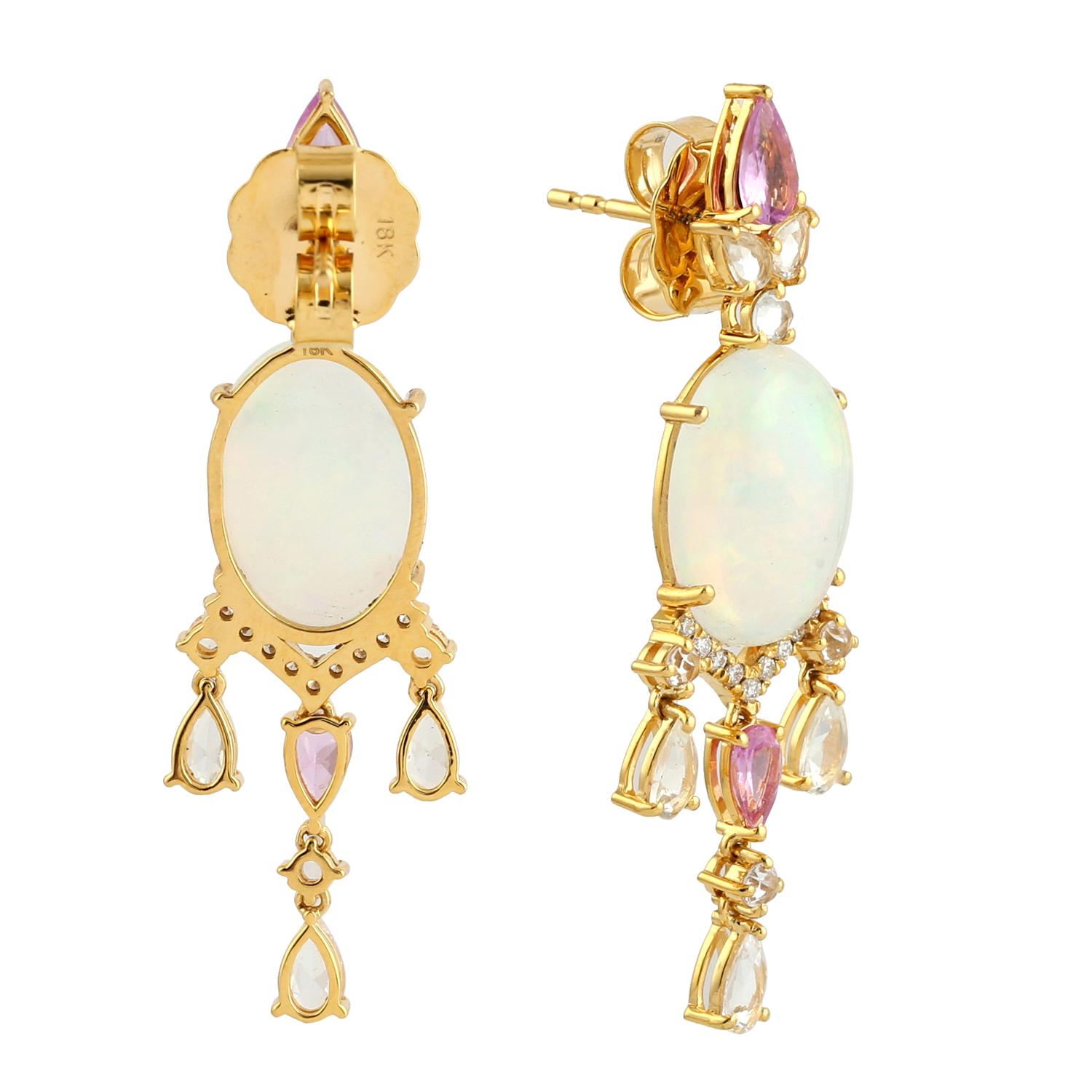 Cast in 14 karat gold. These stud earrings are hand set in 6.03 carats Ethiopian opal, 3.46 carats pink sapphire and .13 carats of sparkling diamonds. 

FOLLOW MEGHNA JEWELS storefront to view the latest collection & exclusive pieces. Meghna Jewels