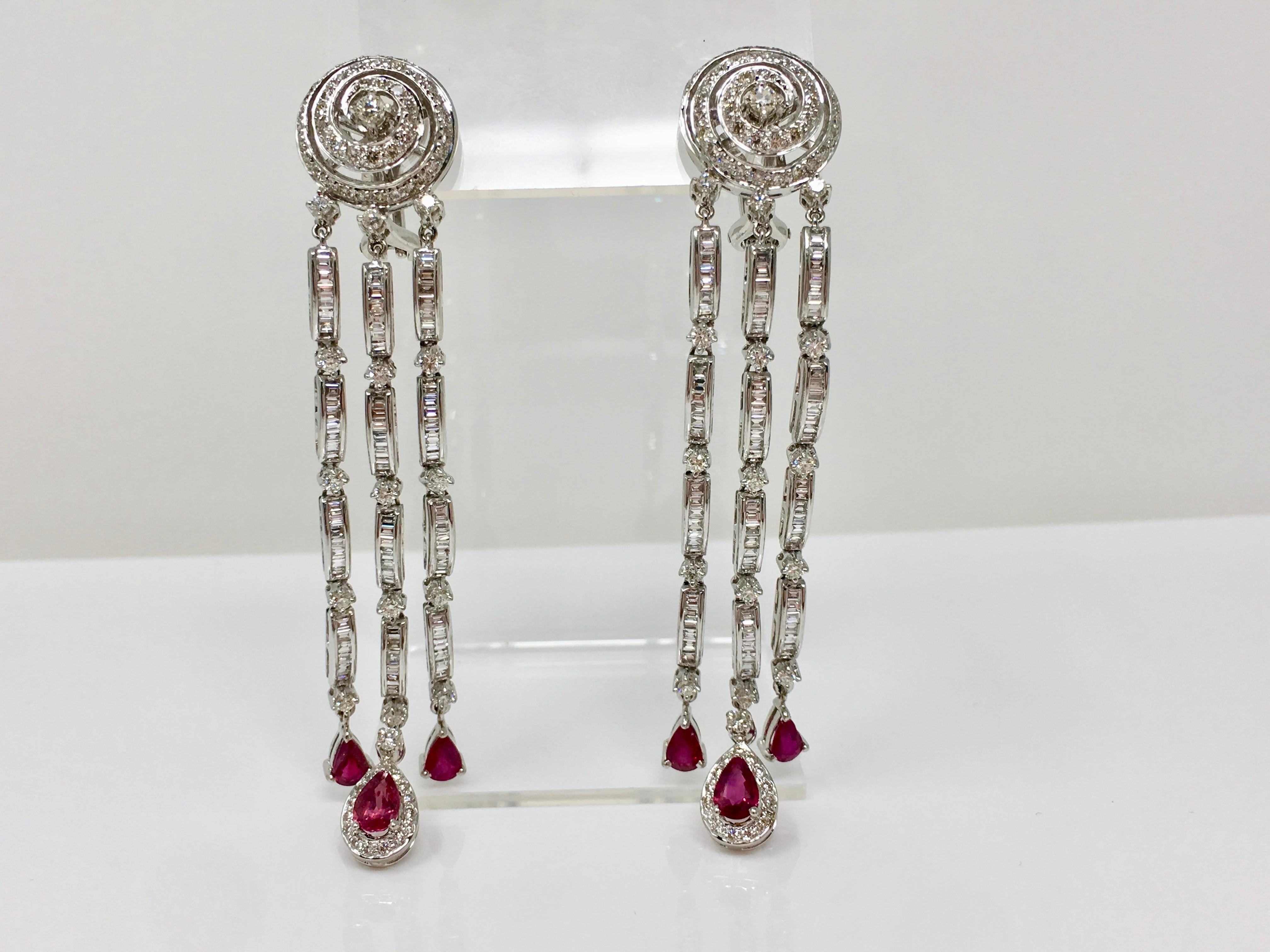 A pair of 18 karats white gold, diamond and ruby earrings from Moguldiam Inc collection, set with white round brilliant diamonds weighing 6.03 carat with GH color and VS clarity and luscious red rubies weighing 3.40 carat. These beautiful one of a