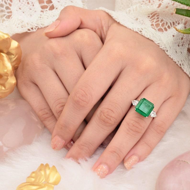 This ring has been meticulously crafted from 14-karat gold.  It is hand set with 6.05 carats emerald & .79 carats of sparkling diamonds. 

The ring is a size 7 and may be resized to larger or smaller upon request. 
FOLLOW  MEGHNA JEWELS storefront