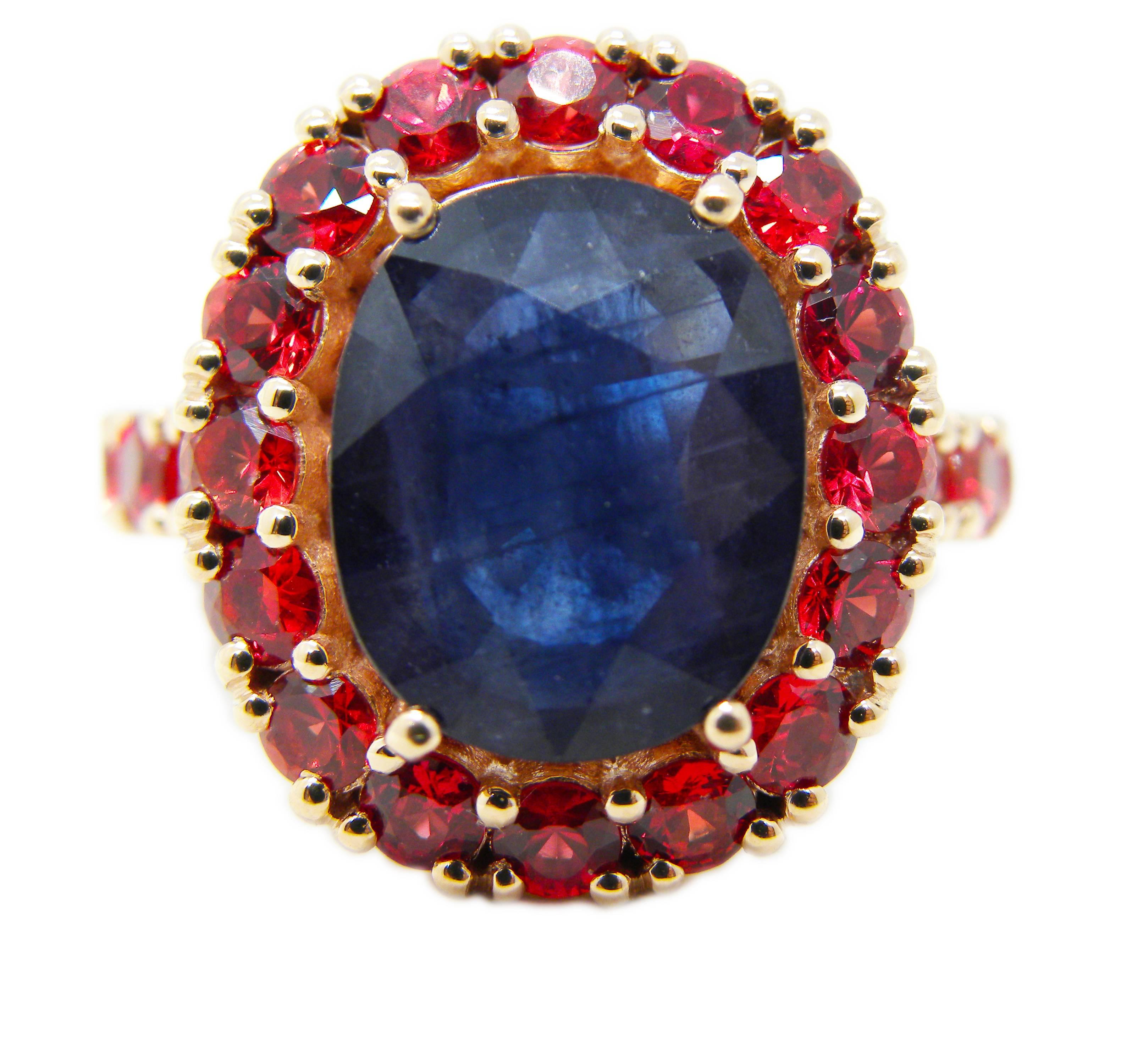 One-of-a-kind Cocktail Ring featuring a 6.05(10.80x13.40mm) Carat Natural Oval Sapphire surrounded by 3.81 Carat Red Spinel in a chic rose gold setting.

US Size 6 3/4, French Size 54
We offer complimentary resizing on this piece.