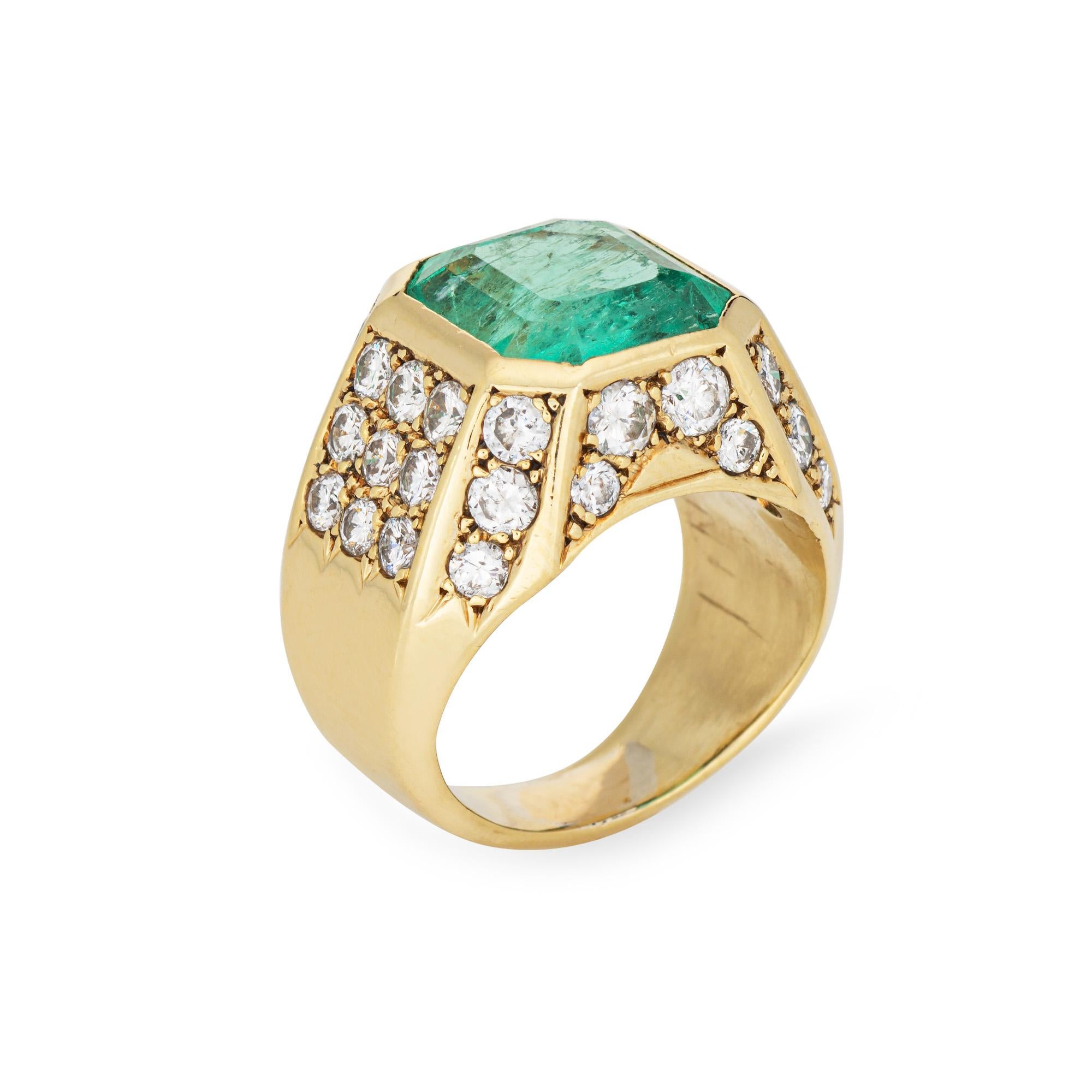 Stylish natural emerald & diamond ring (circa 1980s) crafted in 18k yellow gold. 

Natural emerald measures 11.7mm x 10.8mm x 6.5mm (estimated at 6.05 carats). The emerald is light-medium color, moderately included, good cut. Color and inclusions
