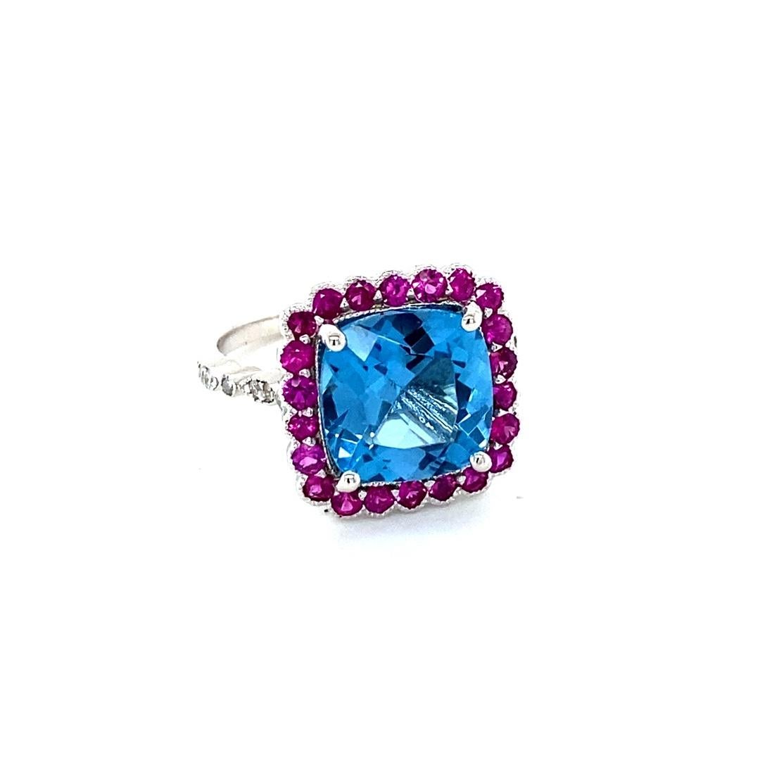 6.06 Carat Blue Topaz Pink Sapphire Diamond White Gold Engagement Ring
Beautiful and Unique to say the Least! 

This ring has a magnificent Cushion Cut Blue Topaz that weighs 5.11 carats and is surrounded by 22 Round Cut Pink Sapphires that weigh