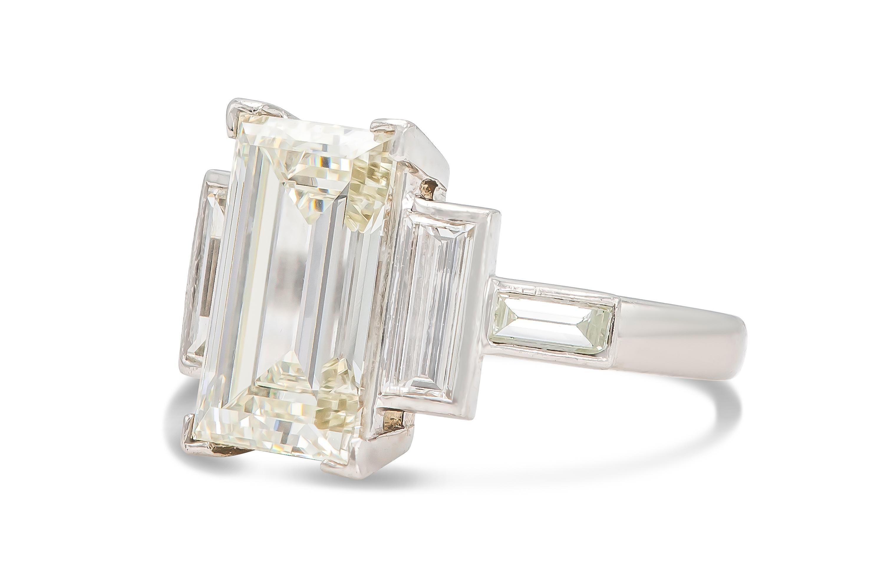 Finely crafted in platinum with a GIA certified Rectangular Step cut Diamond at the center weighing 6.06 carat, L color, VS2 clarity, GIA #5171797007.
The ring also features 4 accenting Baguette cut Diamonds.
Size 8 3/4, resizable