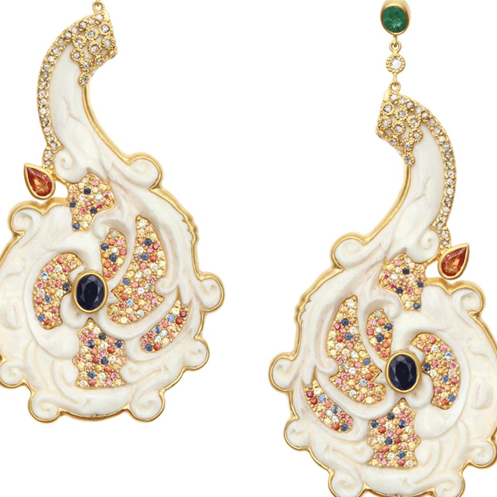 Stunning hand-carved bone earrings set in 20 Karat Yellow Gold with Multi-Sapphire weighing approximately 6.03 carats and Emeralds at 0.65 carats with Diamonds 1.55 carats. Brought to you from the Bali collection inspired by their waterfalls and