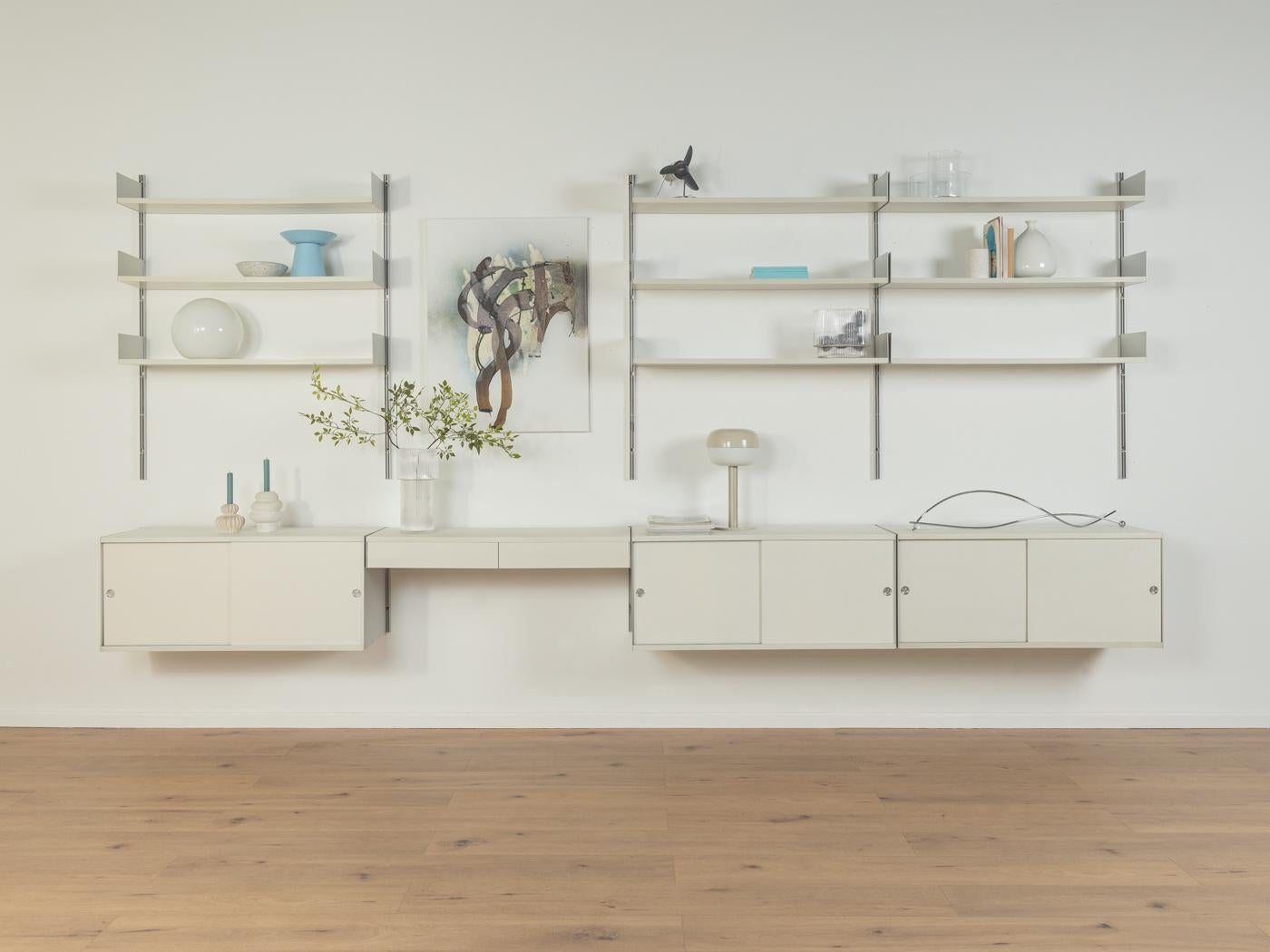 Modular 606 shelving system by Dieter Rams for Vitsœ from the 1960s. High-quality construction consisting of ten aluminum E-Tracks, nine shelves, three cabinets with sliding doors and one shelf with two drawers.

Quality Features:
-accomplished