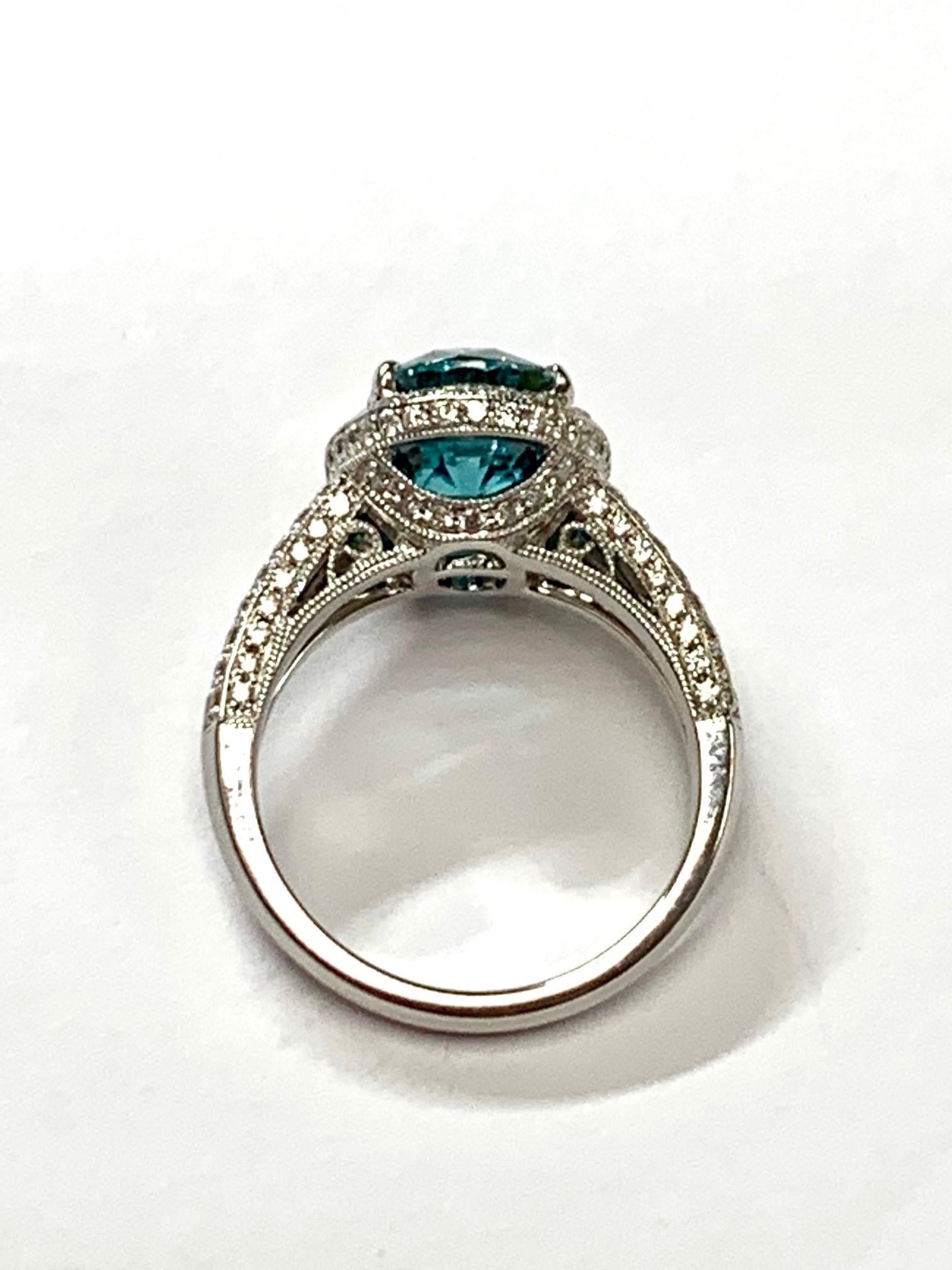 6.07 Carat  Blue Zircon set in 18kw ring surrounded with 1.0 ct pave set diamonds around, in the gallery, half way on the  split shank,and the side of the ring 