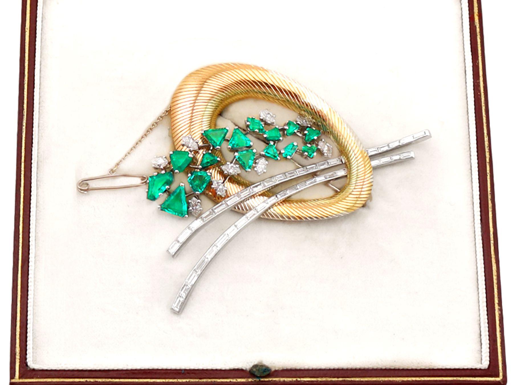 A stunning, fine and impressive, large antique 4.05 carat diamond and 6.07 carat emerald, 18 karat yellow gold and platinum Art Deco style brooch made by Garrards & Co Ltd; part of our diverse antique boxed jewelry and estate jewelry