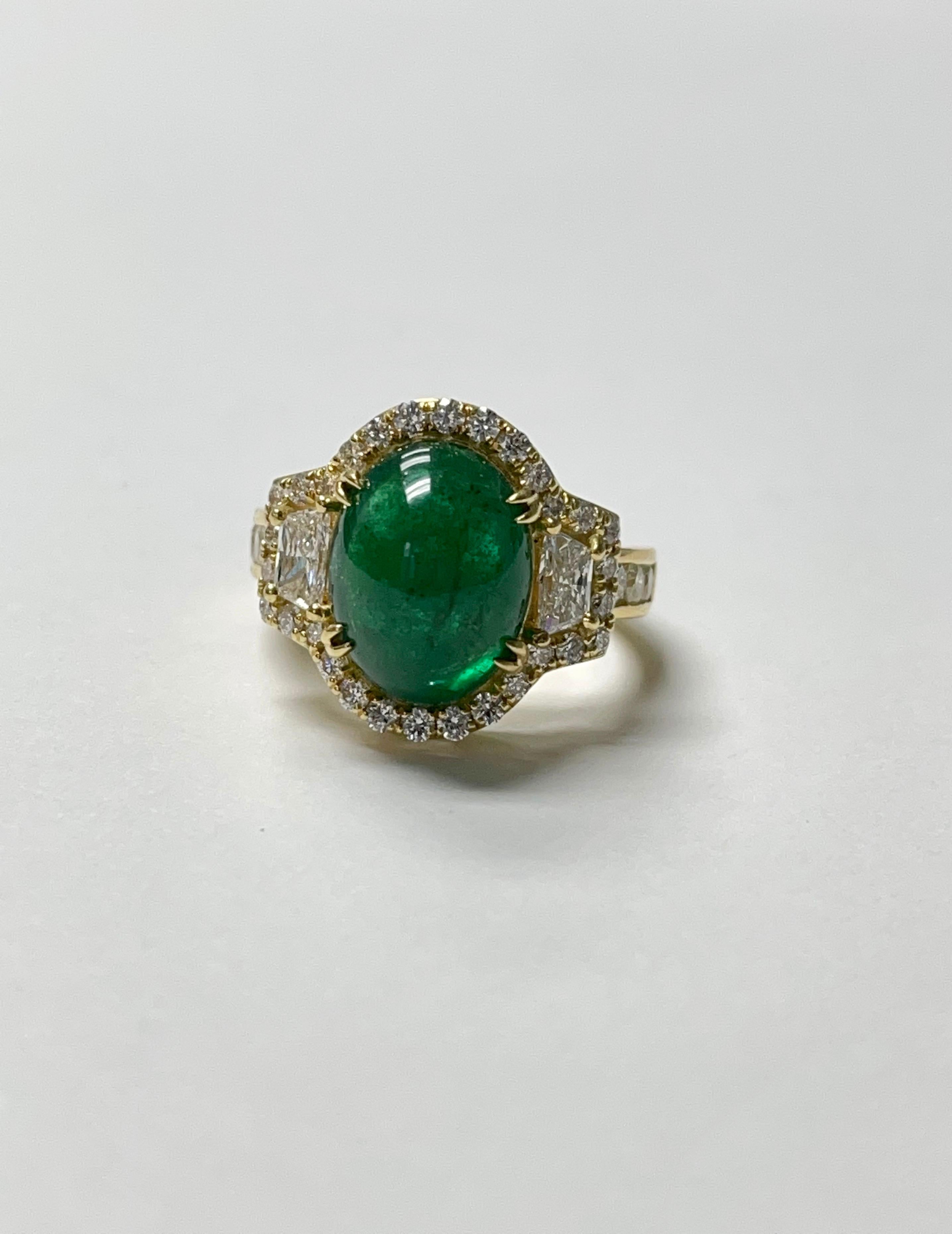Elegant and classy oval cabochon emerald ring handcrafted in 18 k yellow gold.
The details are as follows : 
Emerald weight : 6.08 carat 
Diamond weight : 1.29 carat 
Metal : 18k yellow gold 
Measurements : ring head : 3/4 inch 