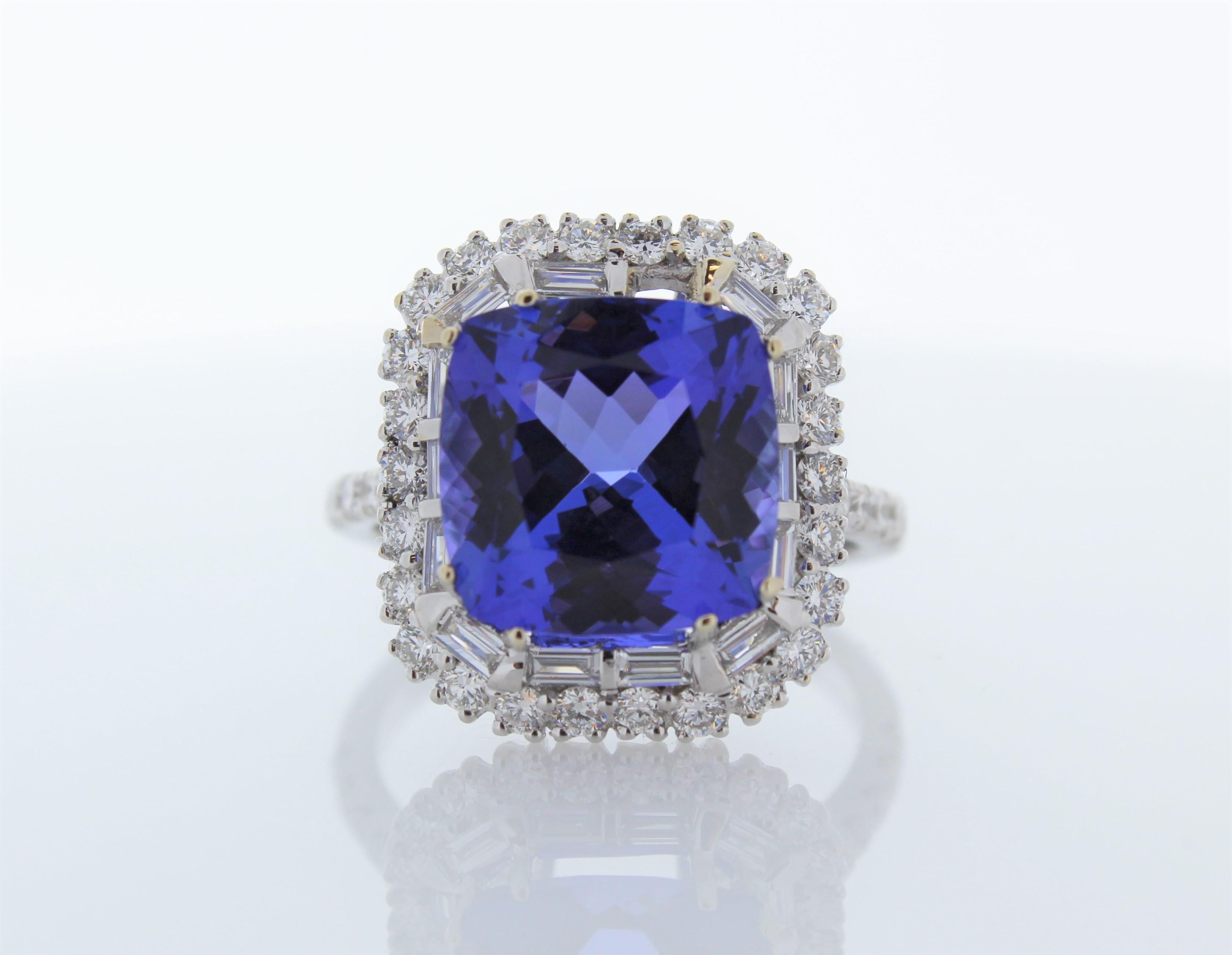 This is a cocktail ring that showcases a 6.09 carat cushion cut tanzanite. It has diamonds on the band and around the gemstone totaling 1.20 carats. Designed in brightly polished 18 K gold, this gorgeous ring exudes sophistication and individual
