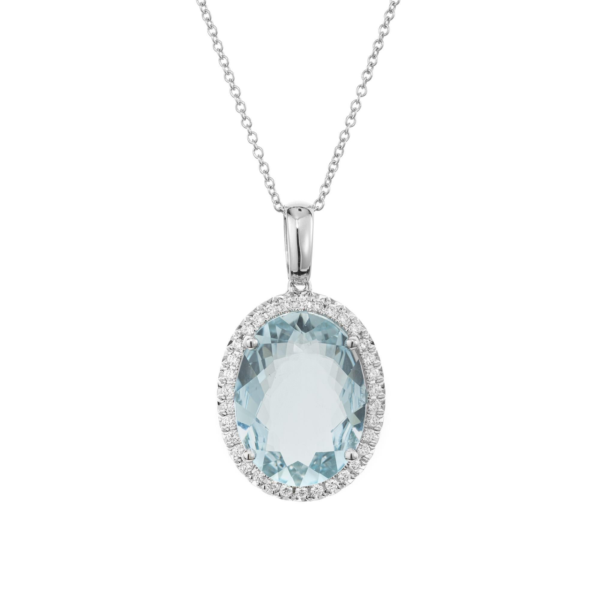 Stunning Aqua and diamond pendant necklace. This exquisite piece features a captivating 6.09ct oval aquamarine center gemstone complemented by dazzling halo of 34 round brilliant cut diamonds. The pendant is 14k white gold and completed with a 14k