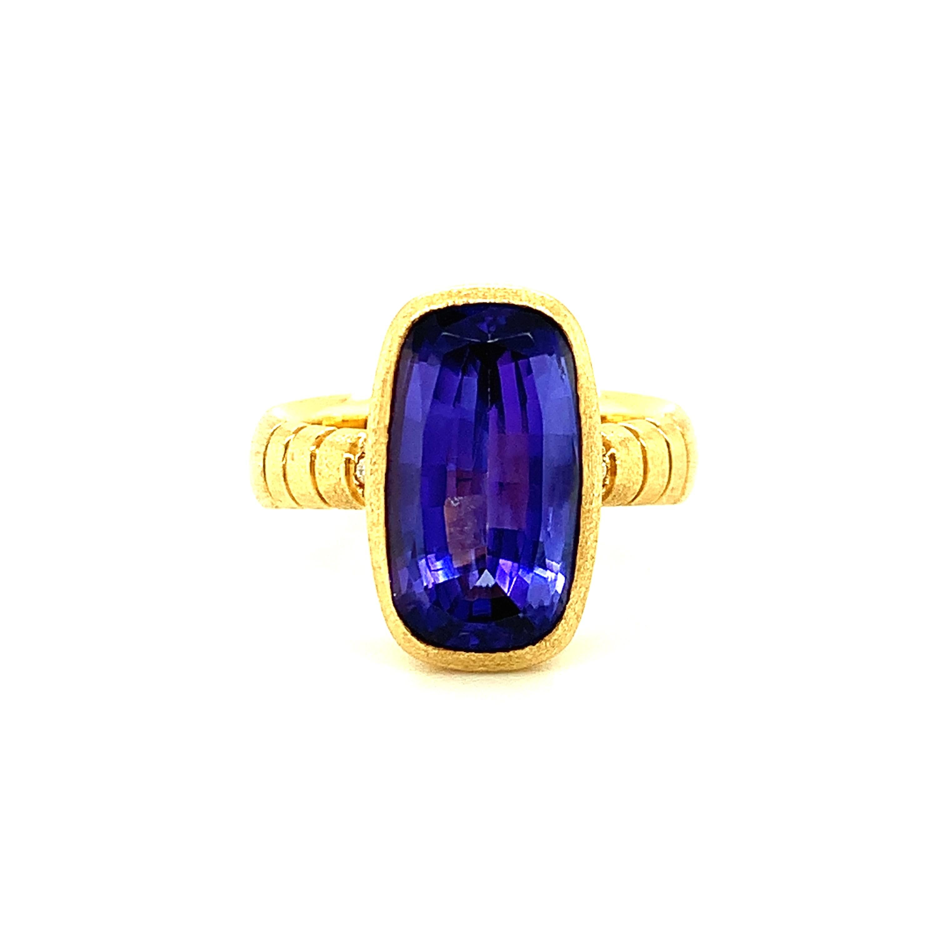 This one-of-a-kind ring shows off the beautiful, elongated shape of this richly colored gem tanzanite! The 6.09 carat tanzanite is a stunning bluish purple color with unusually strong saturation. This ring was handmade in 18k yellow gold, with a