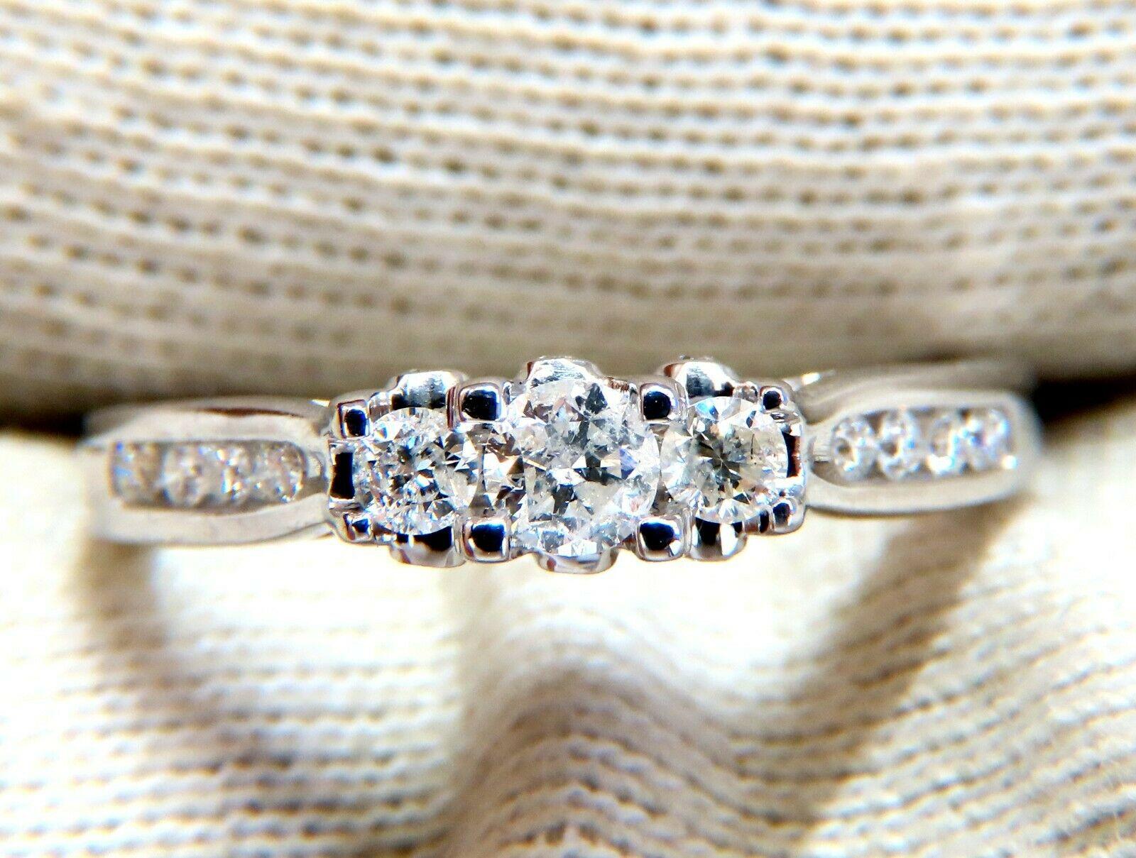 Classic Raised Three Stone

.60ct Total Weight of all Diamonds.

Center: 3.5mm

I-1 clarity  H color.

14kt white gold.

2.4 Grams

Ring Depth: 6.2mm

Current ring size: 7

May professionally resize, please inquire.