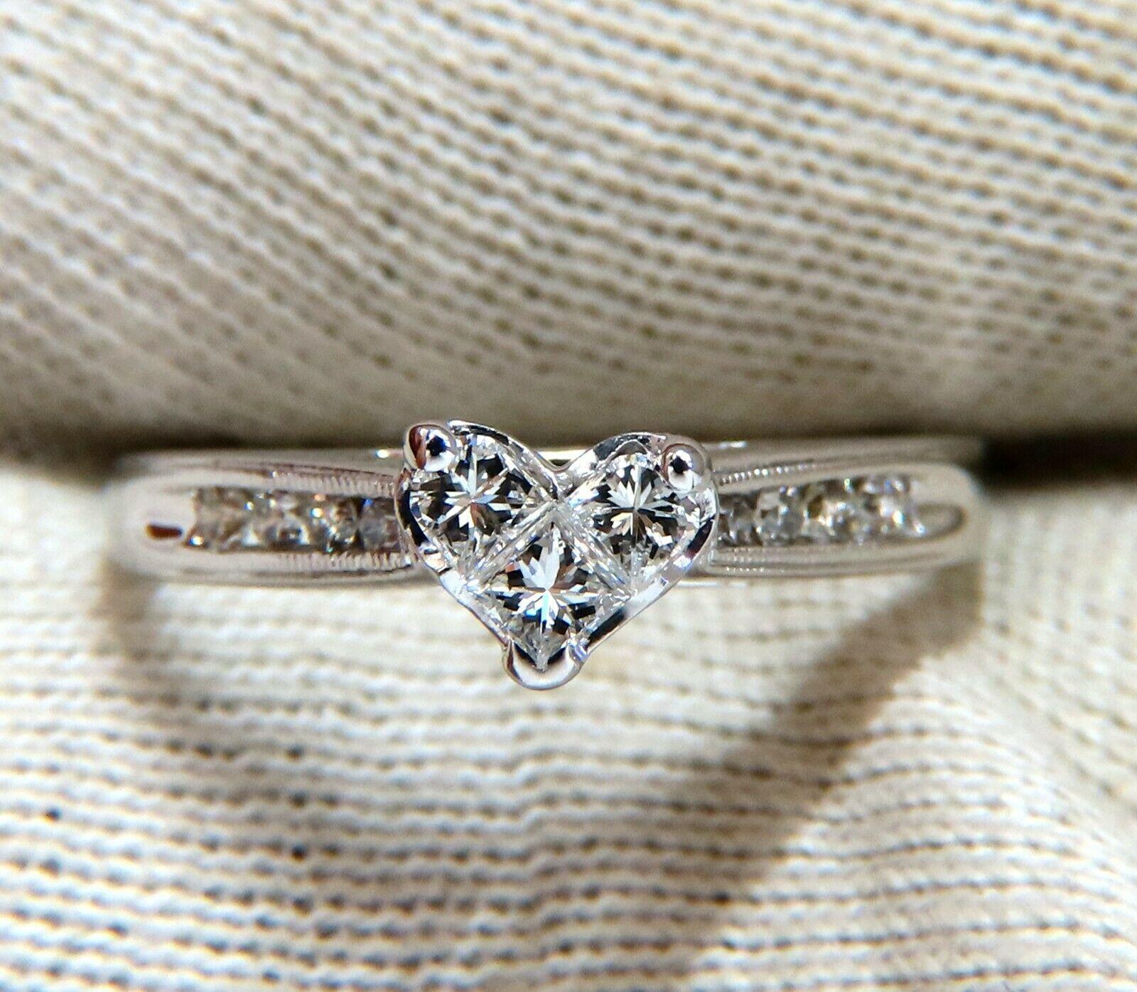 Princess Cut Cluster Heart 

(Three Diamonds Fused Together)

.60ct Natural Princess & Round Diamonds 

Vs-2 clarity H color.

14kt white gold

2.8 Grams

Overall ring: 5.6 mm (Heart)

Depth: 7.5mm

Current ring size: 8

May professionally resize,