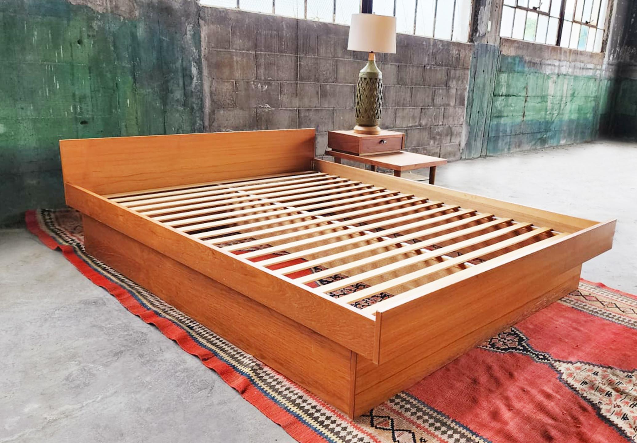 Very beautiful teak danish Queen bed with bed slats. Ready to go.  Very beautiful clean, classic teak bed design.

Sleek Danish mid century design, a Beautiful teak grain veneer frame, Very sought after Original Vintage Danish Modern Teak Queen Bed