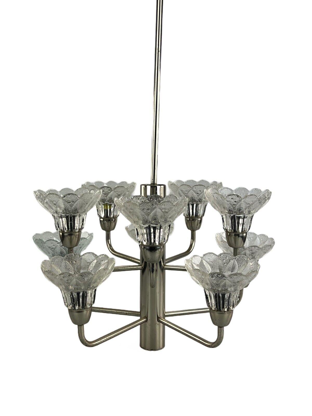60s 70s Lamp fixture chandelier glass space age design.

Object: chandelier

Manufacturer:

Condition: good

Age: around 1960-1970

Dimensions:

Diameter = 50cm
Hanging height = 86cm

Other notes:

10x E14 socket

The pictures