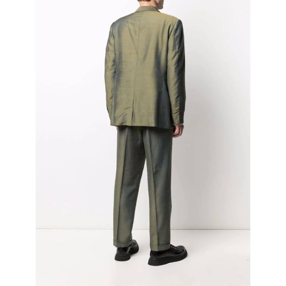 A.N.G.E.L.O. Vintage Cult iridescent green silk blend suit. Classic lapel collar jacket and front button closure. Trousers with front pleat and botton and zip closure.

The item shows a slight halo on the jacket back as shown in the