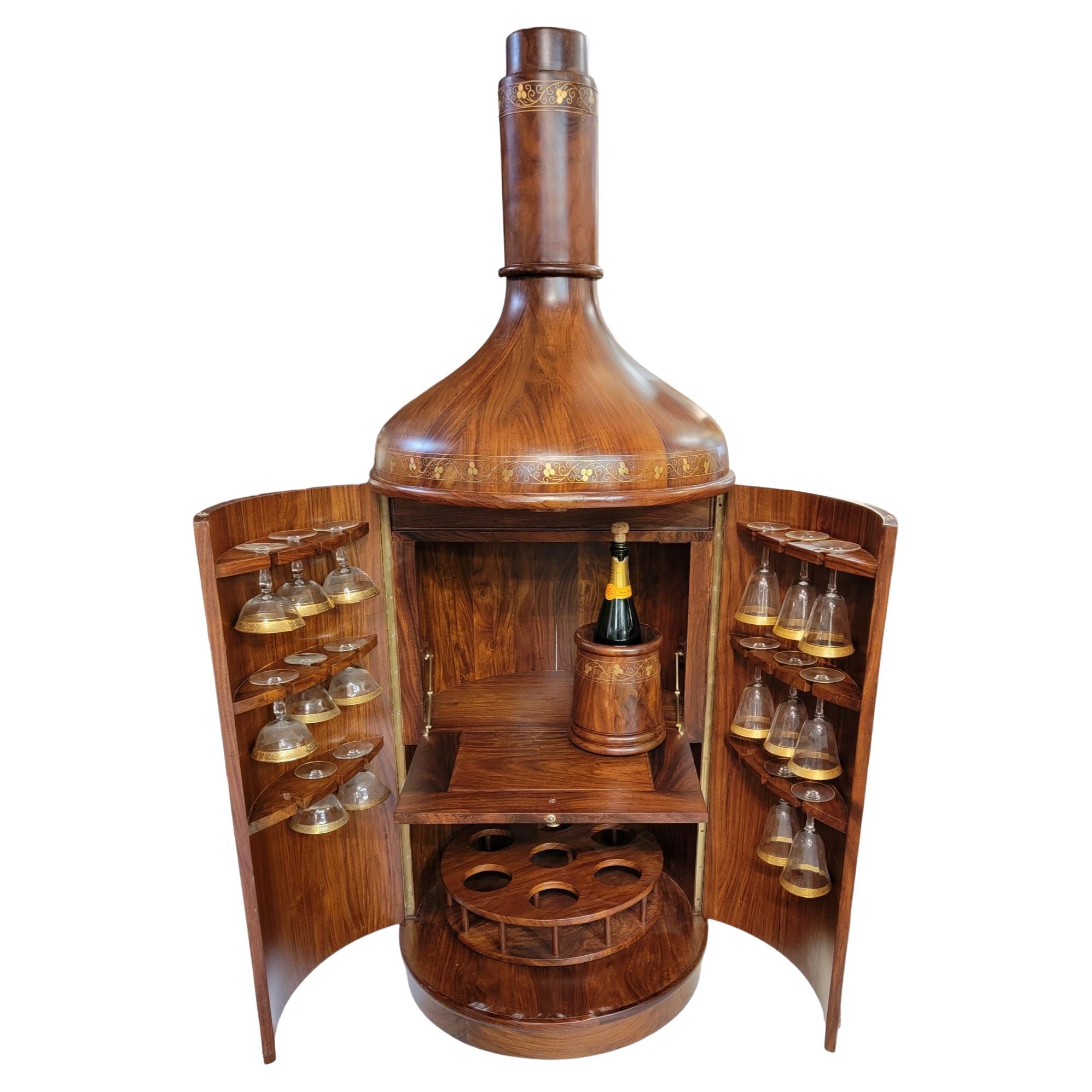 1960s Aldo Tura Style Bras Inlayed Bottle Shaped Mahogany Bar. There is some inlay that is is protruding from the original groove. All the hand made inlay is intact. 
Measures approx 72 high x 25 in diameter

