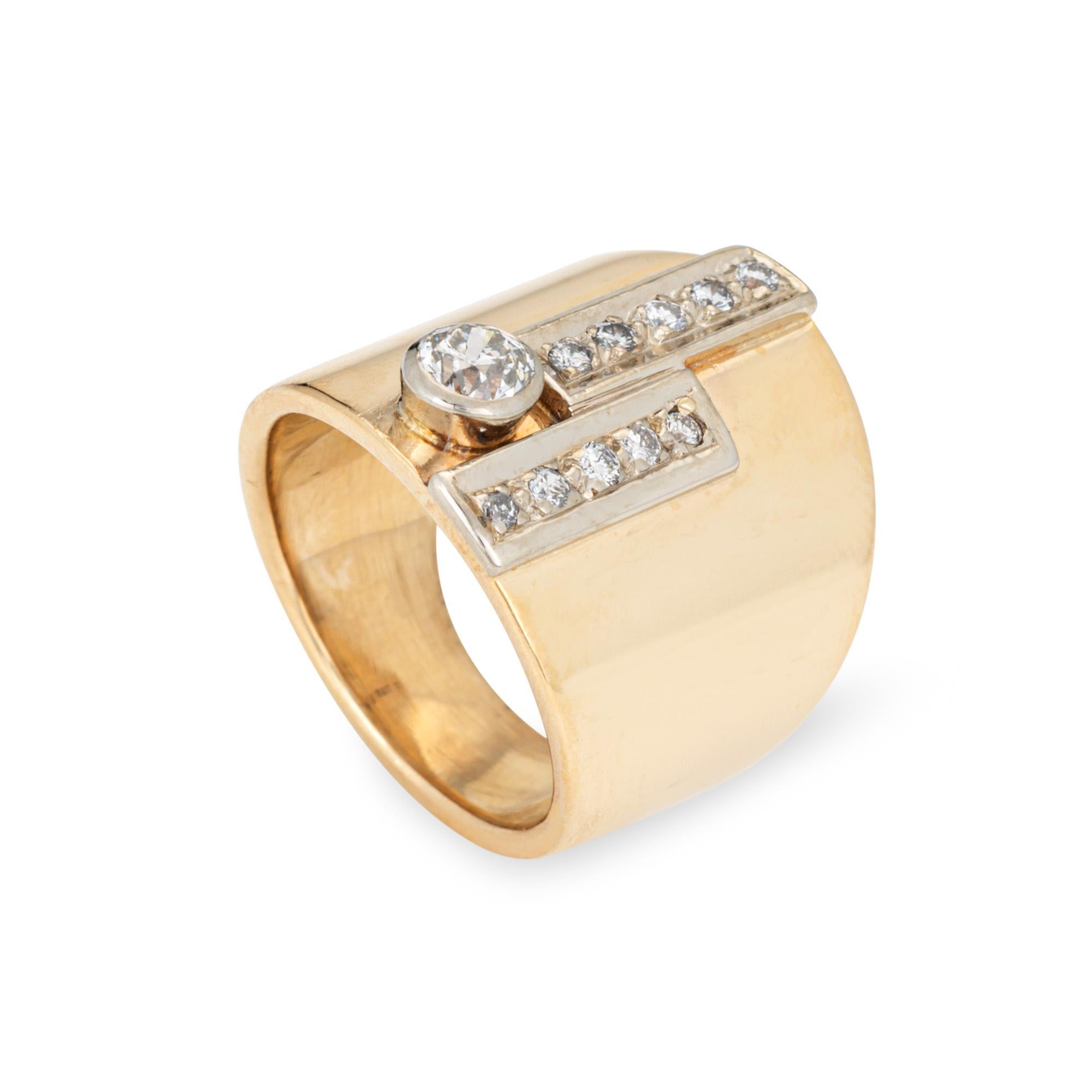 Stylish vintage wide band diamond ring crafted in 14 karat yellow gold (circa 1960s). 

European cut diamond is estimated at 0.25 carats, flanked with 10 smaller estimated 0.01 carat diamonds. The total diamond weight is estimated at 0.35 carats