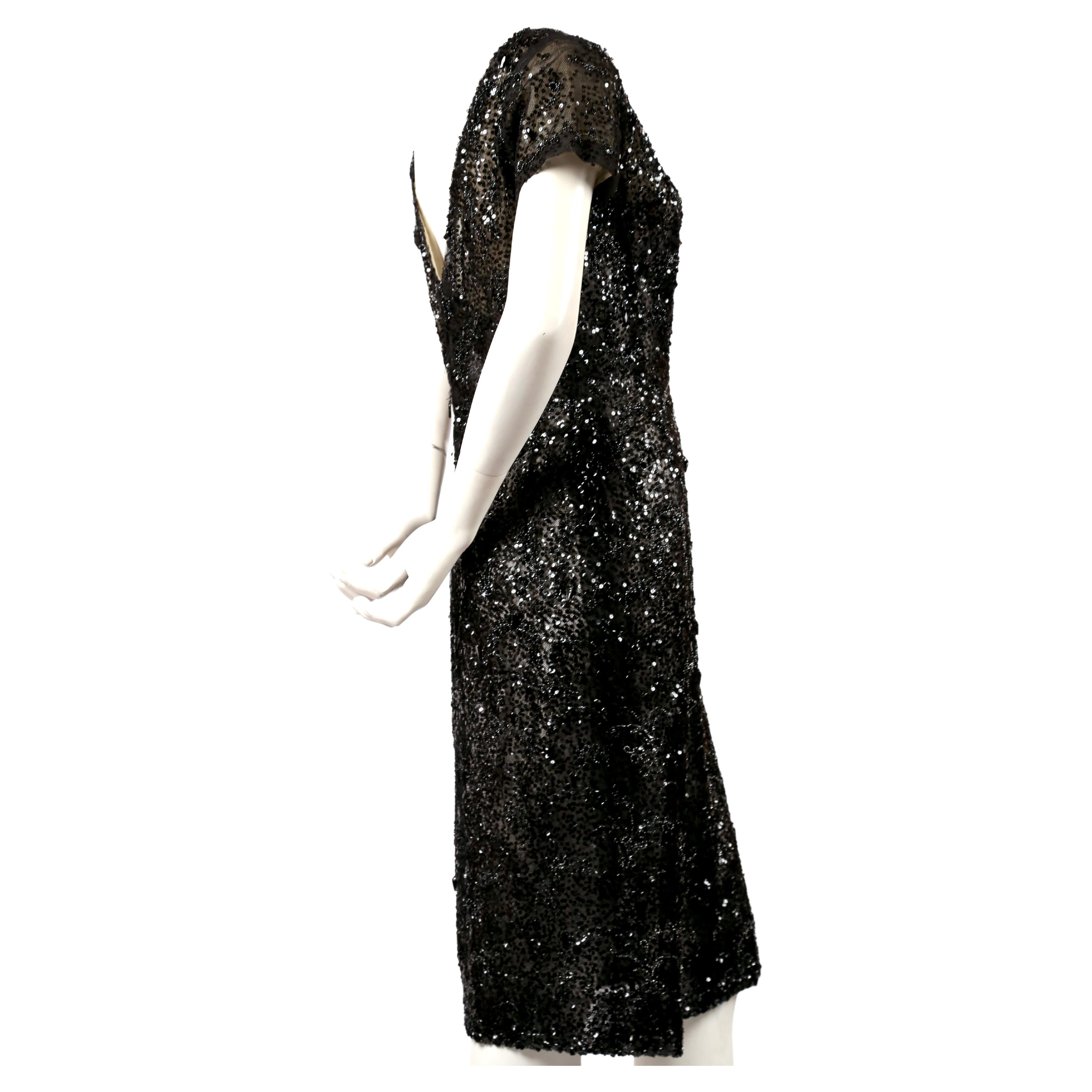 Very rare, jet-black lace, semi-sheer, haute couture dress with sequins and beads designed by Cristobal Balenciaga for his Eisa boutique dating to the early 1960's. Fits a size 4-6. Approximate measurements: shoulders along top 14