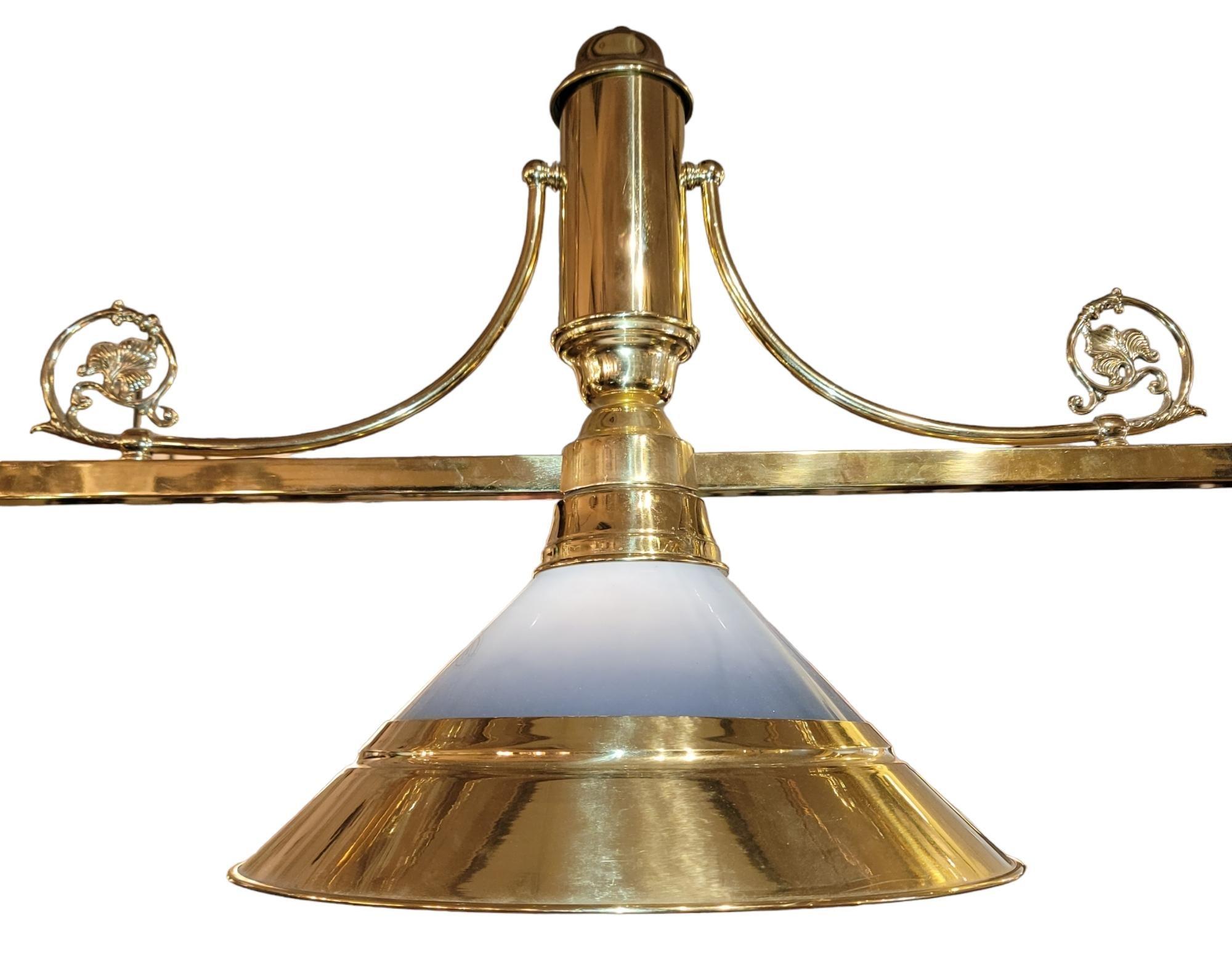 French brass three light Chandelier with a double chain hanging set up. Leaflet motif to the left and right of the center light. Each light is found to be in working order and depending on light can be very bright or dimly lit depending on the bulb