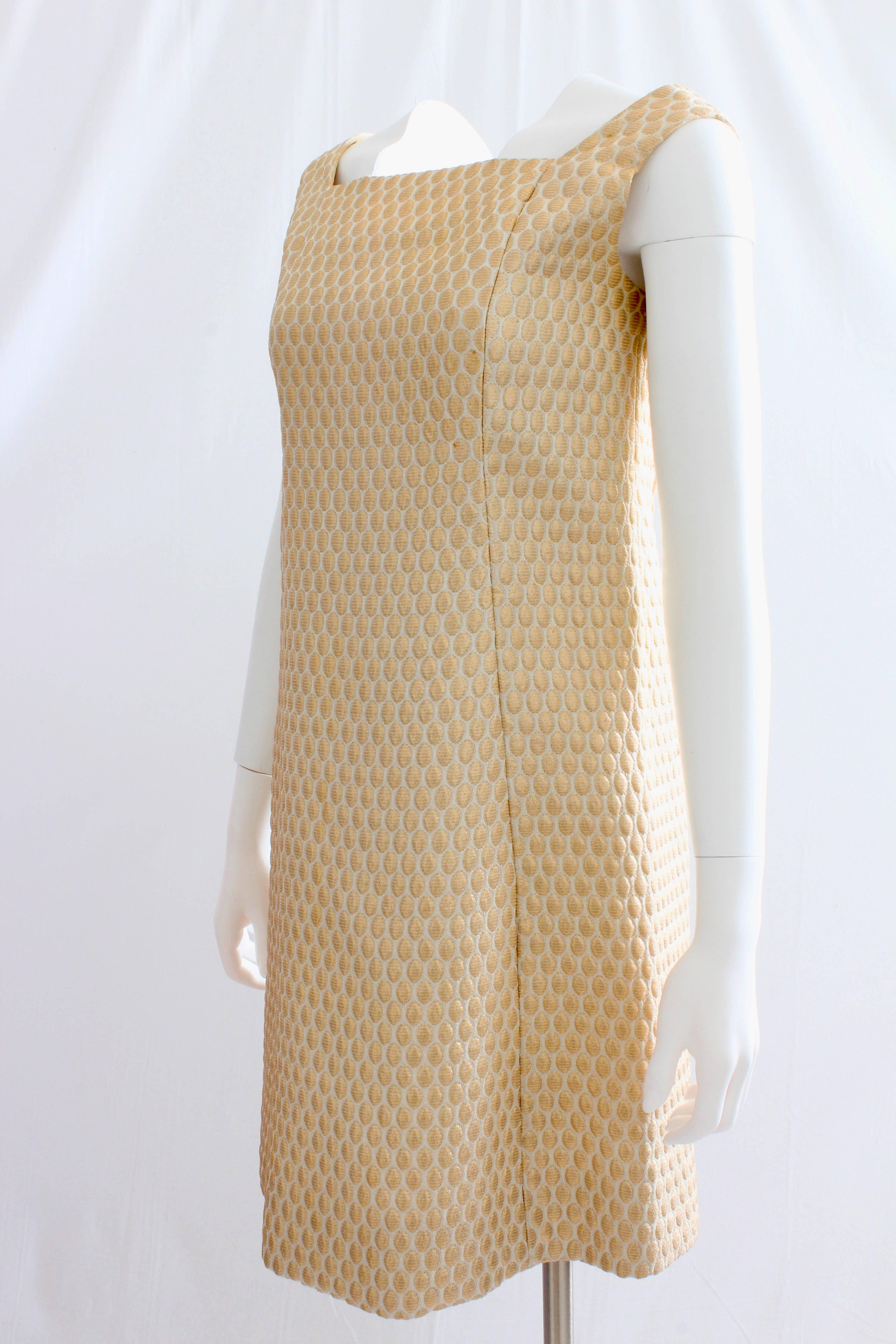 This fabulous little dress was made by Hannah Troy, most likely in the mid 1960s.  Made from what we believe is a poly blend fabric (no content label), it features gold lurex oval-shaped polka dots throughout.  Fully-lined with a A-line silhouette,
