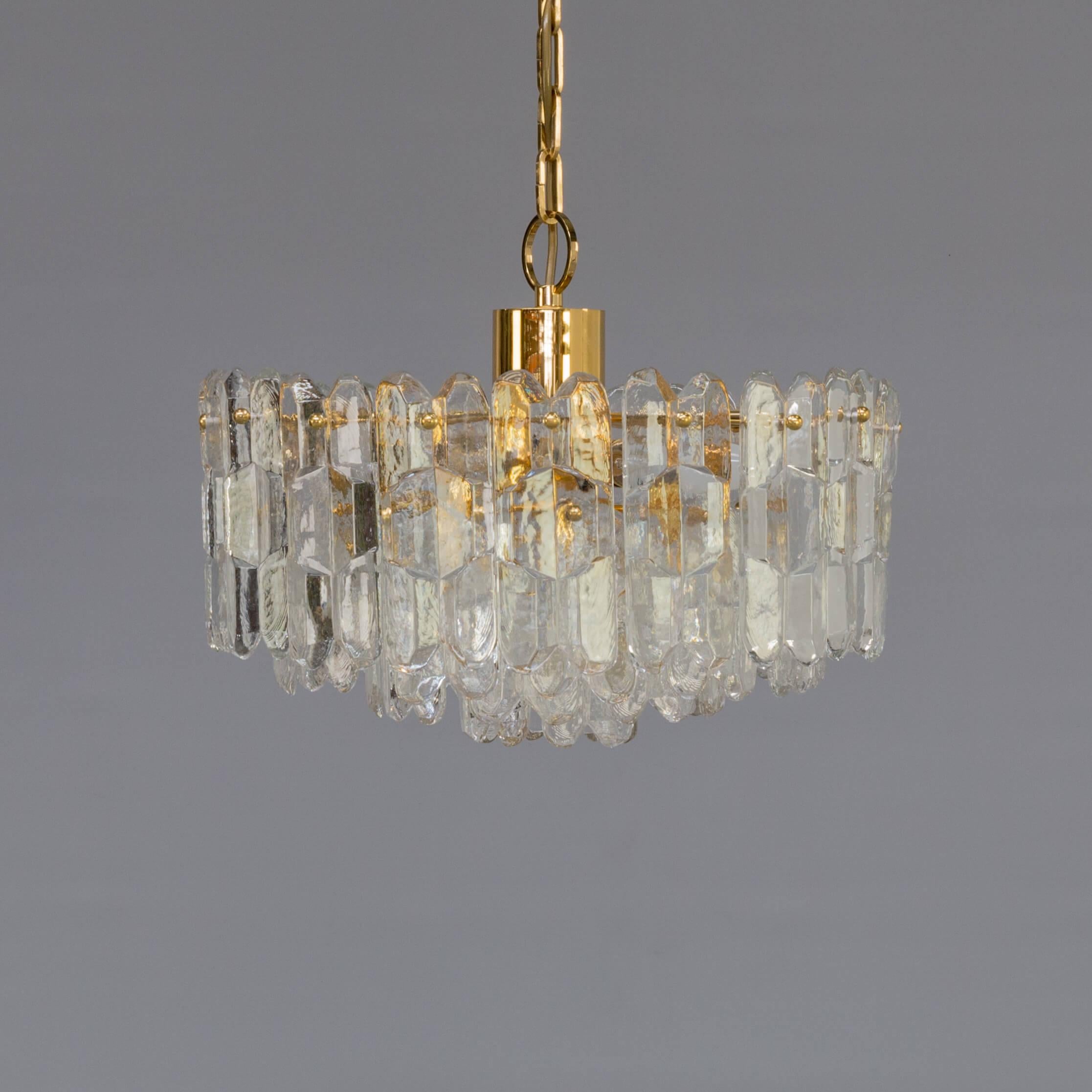 Rare and very beautiful pendant chandelier with brass frame on which beautiful individual glass elements are being mounted. Very sophisticated hanging lamp in good condition consistent with age and use. Small E14 fittings.
  