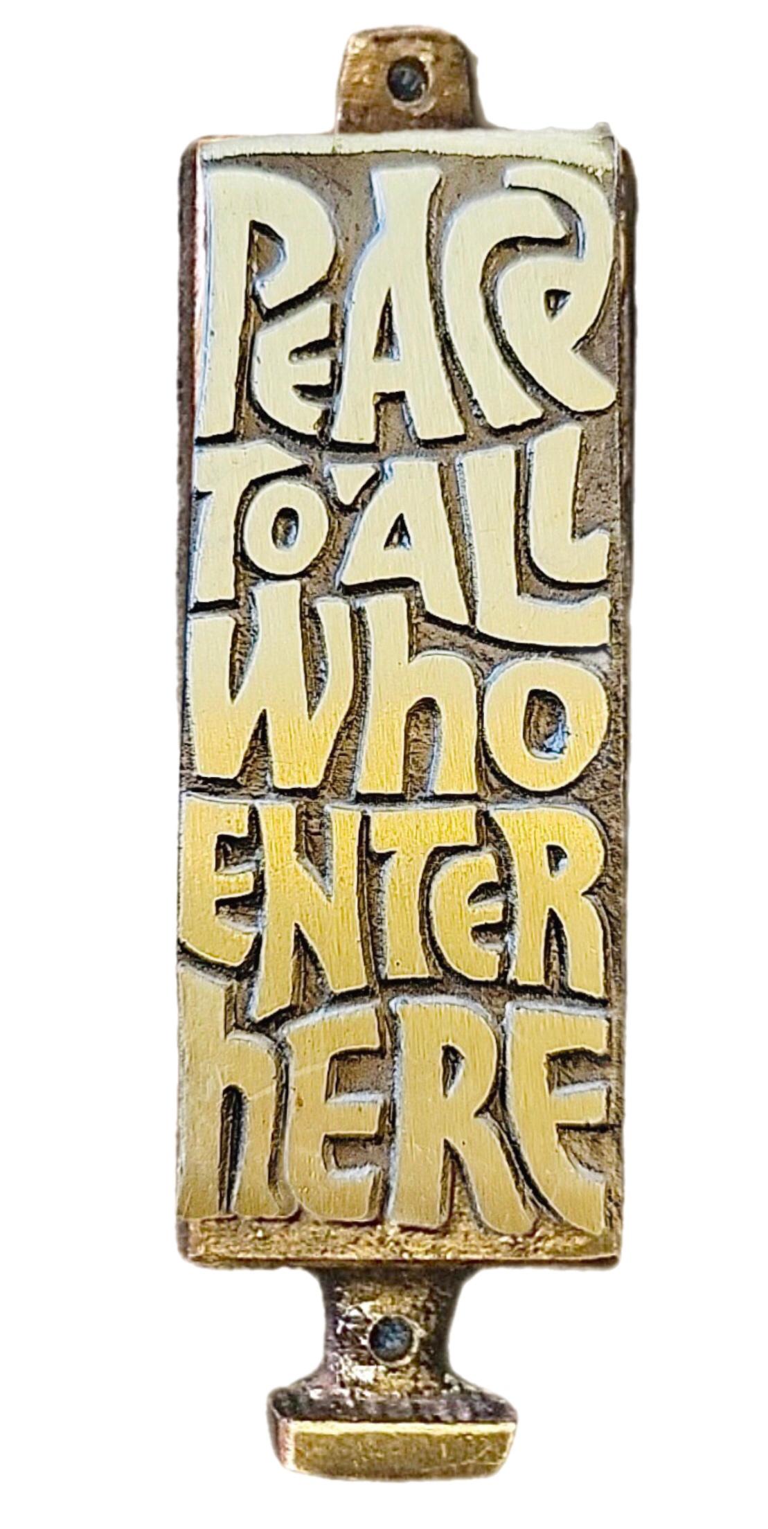 Inviting, modernist, brass door, Mezuzah with a delightfully “groovy” incised font. 

The piece was made in 1969 by.Terra Sancta of Israel. 

The original scroll, as often is the case,
 is missing. There are numerous sources, even Amazon,  to