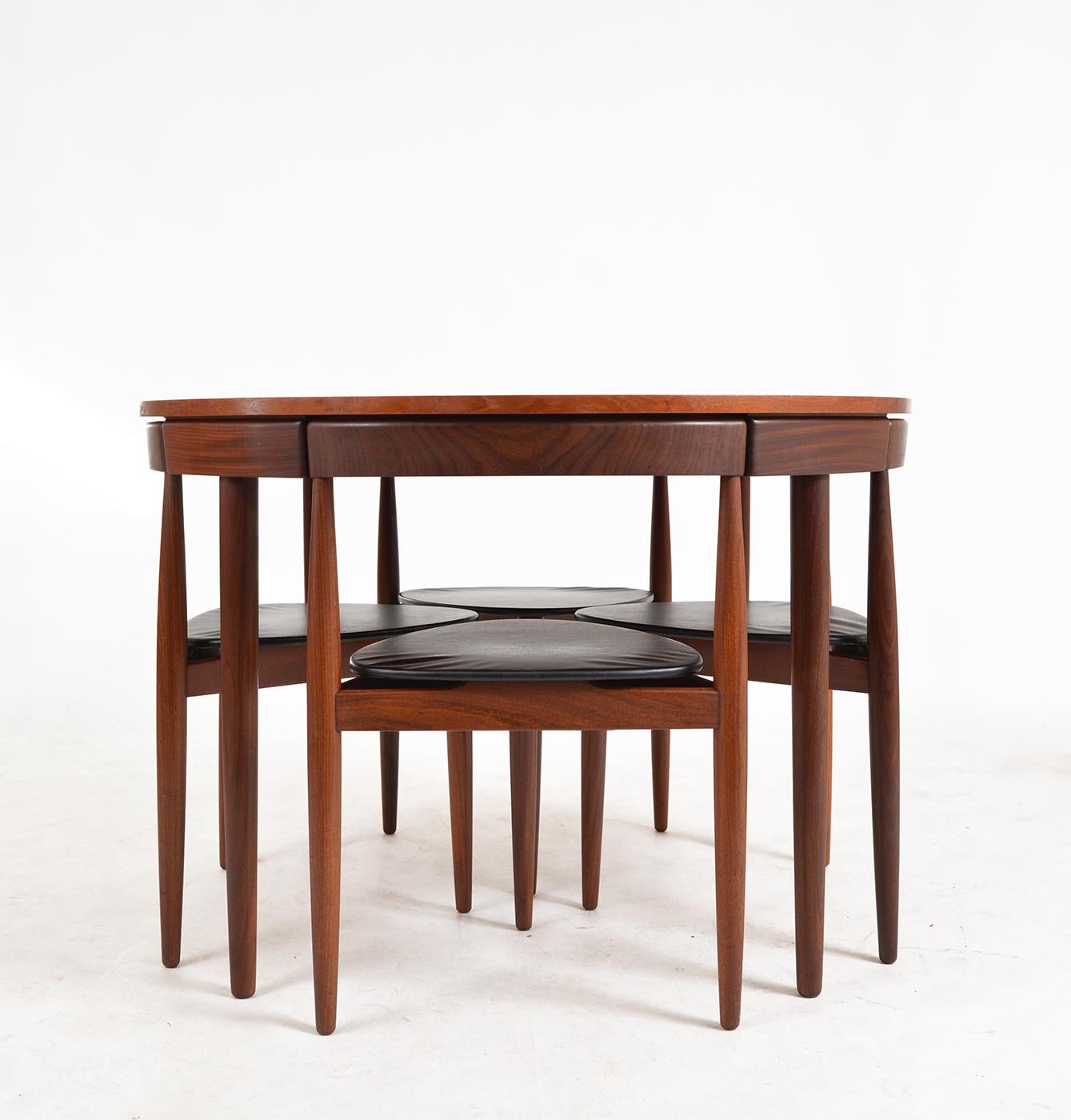 The Model 631 “Roundette” Dining Suite was designed by Hans Olsen in 1952 for Frem Røjle, and is an ingenious design in which the three-legged, curved chairs fit seamlessly within the table’s apron forming a continuous band of beautifully grained