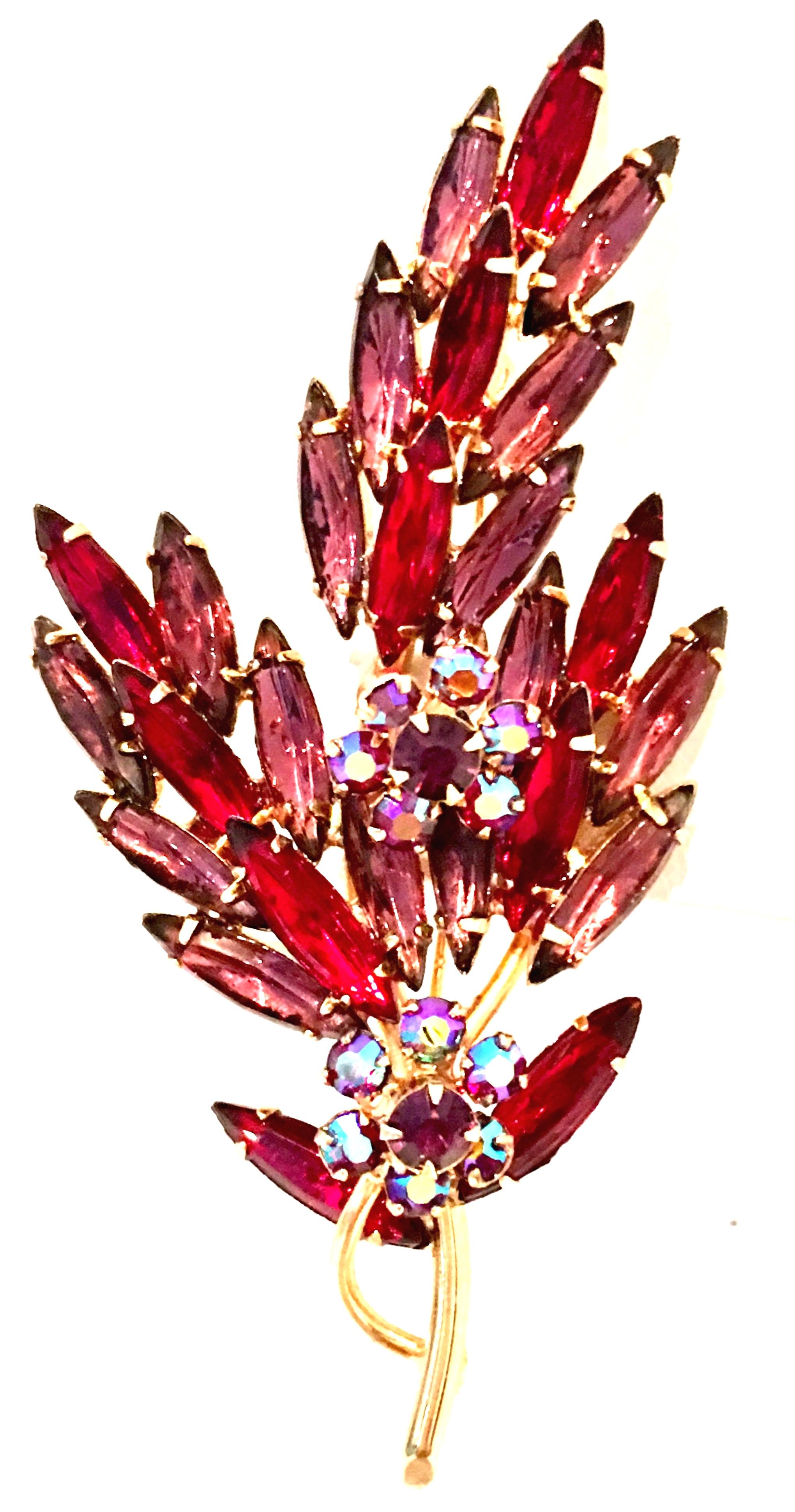 1960'S Monumental Gold & Austrian Crystal Flower Brooch. This lovely brooch features gold plate prong set brilliant Austrian crystal rhinestones of ruby red, amethyst and aurora borealis. 