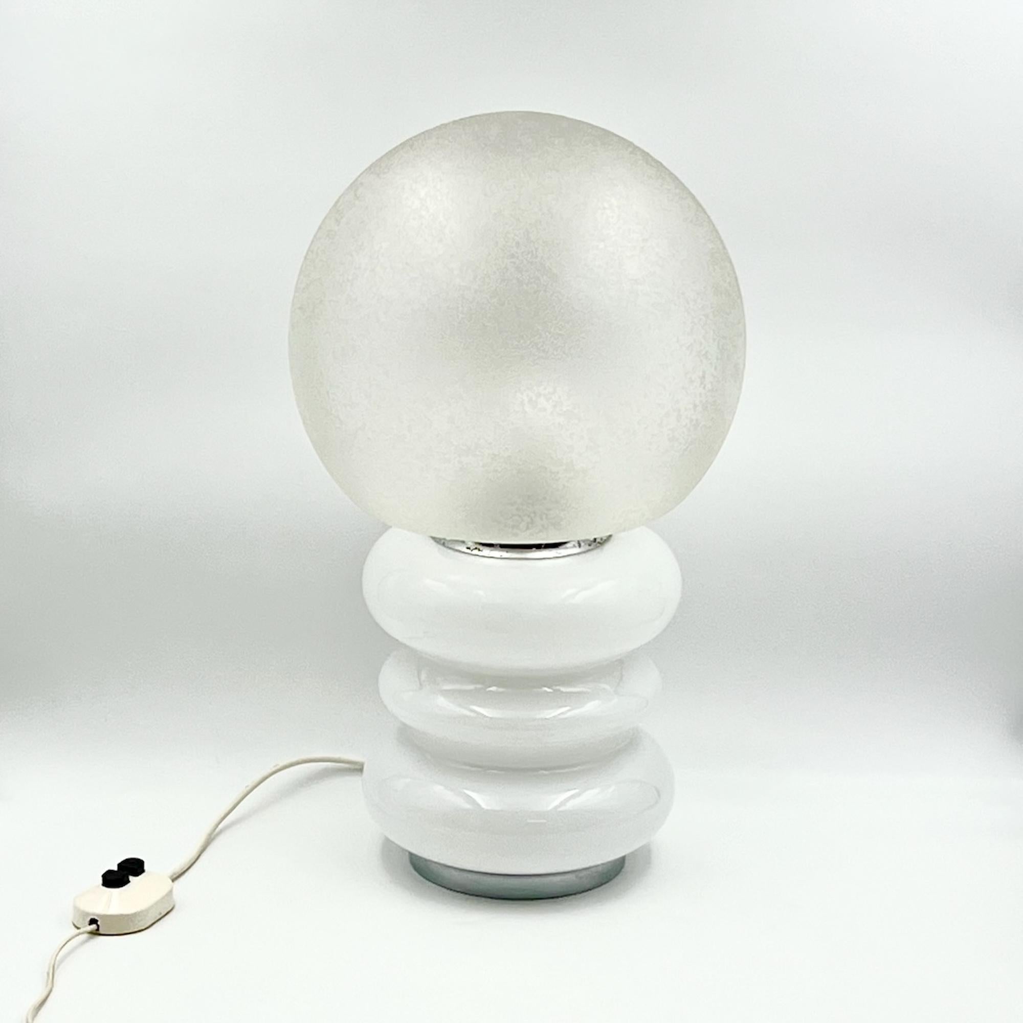 Elegant and rare Glass Base Table Lamp in Murano glass, an exquisite piece  Mazzega style. This sophisticated table lamp is a statement of refined taste and luxurious design, perfect for those who appreciate the art of exquisite craftsmanship and