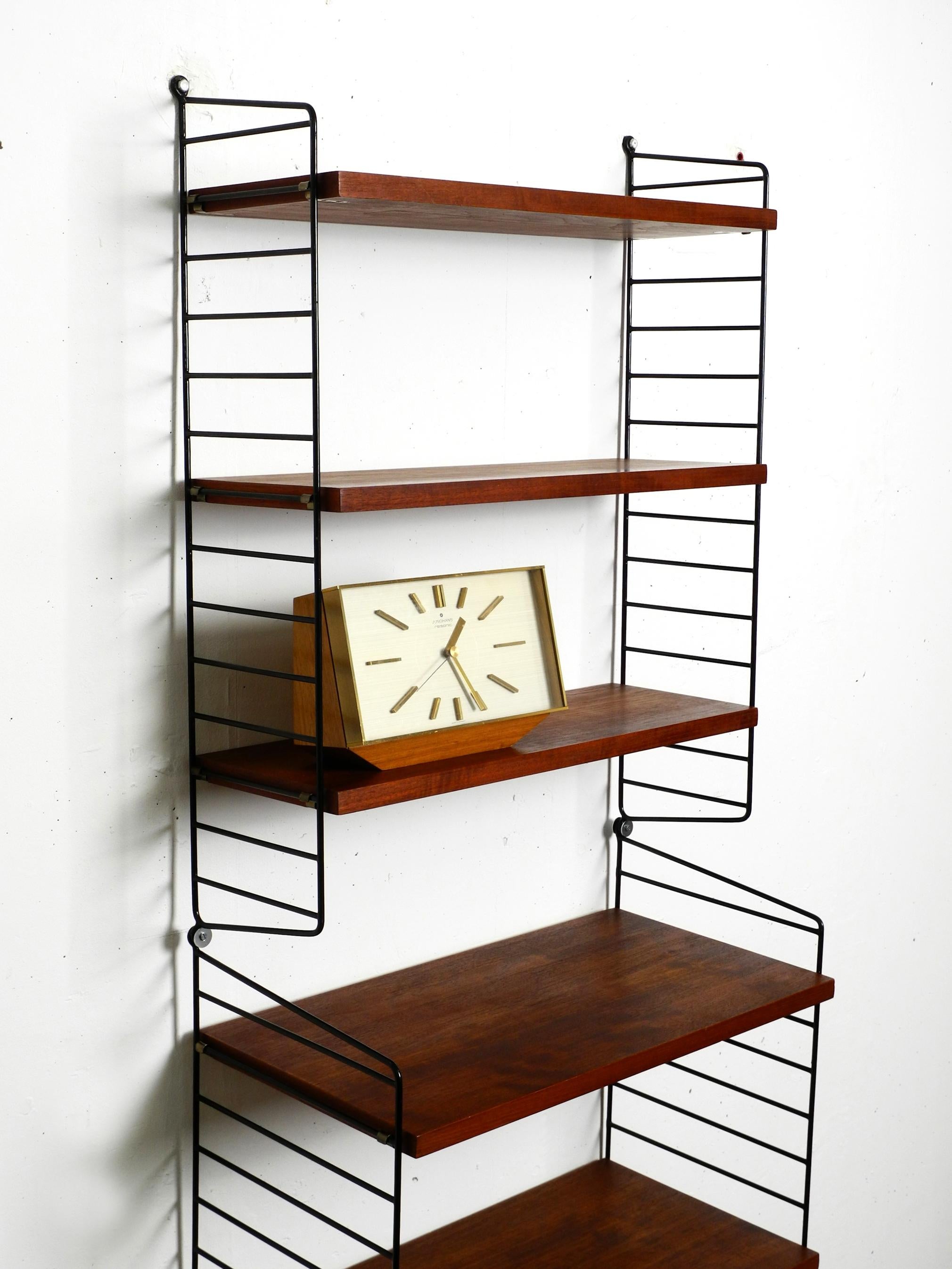 Metal 60s Nisse Strinning dark teak string shelf with six shelves and four ladders