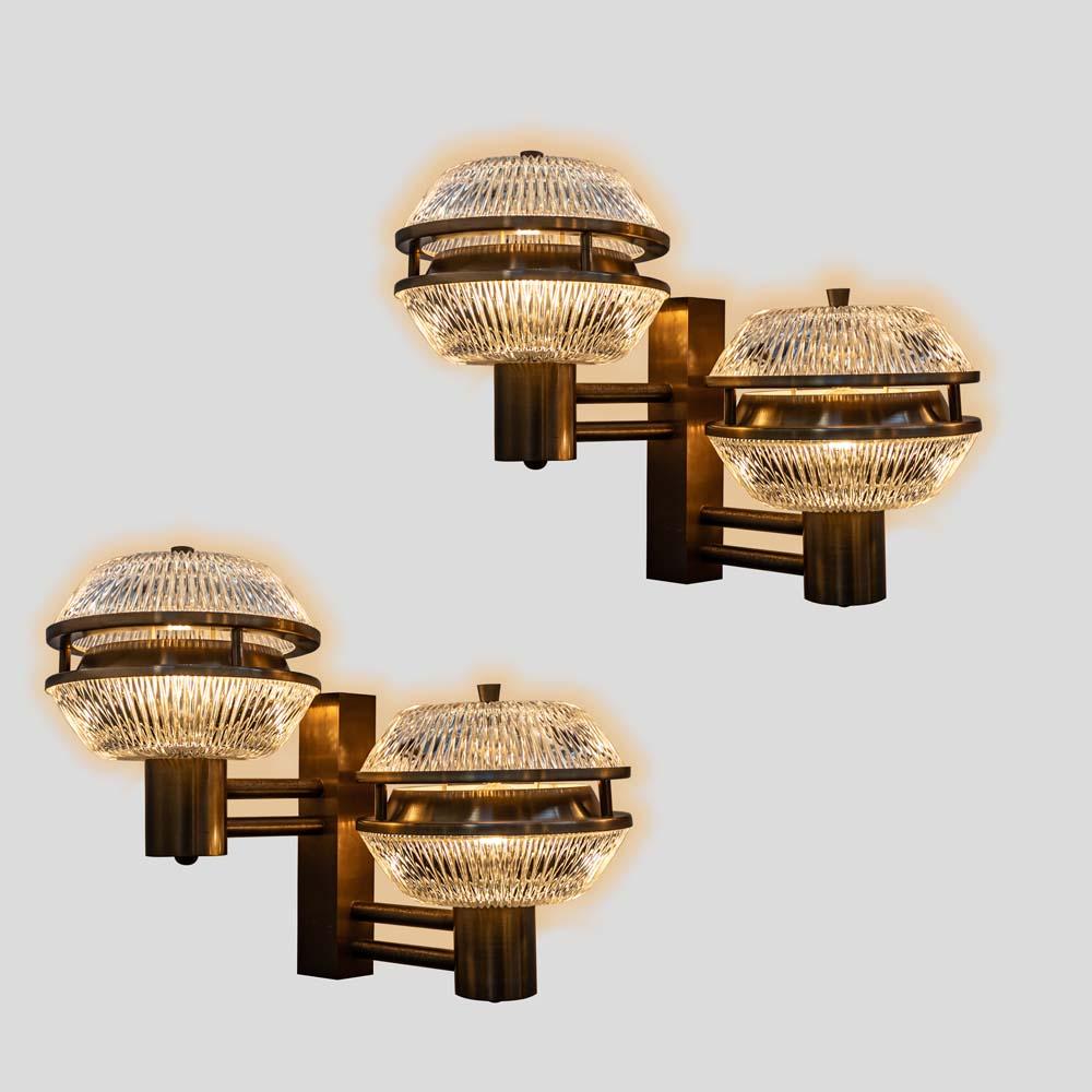 Outstanding Vintage 1960s Pair of Wall Lights with a bronzed  steel structure with double clear pressed glass shades shaped as flying saucers with bronzed metal finish details. this rare pair of sconces are attributed to  Italian designer Segio