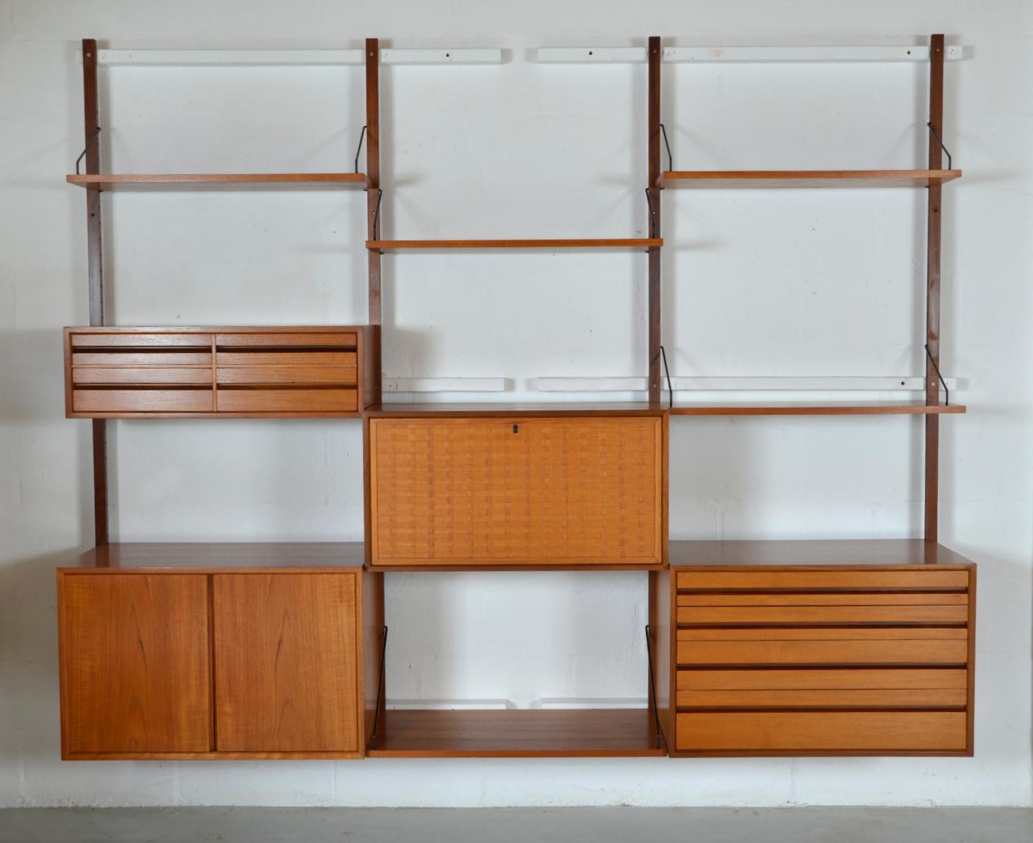 This highly versatile and functional “Royal System” was originally designed by Poul Cadovius in 1948. This useful three-bay teak shelving system offers a wide variety of storage and display options, which can be configured to your choice. The set