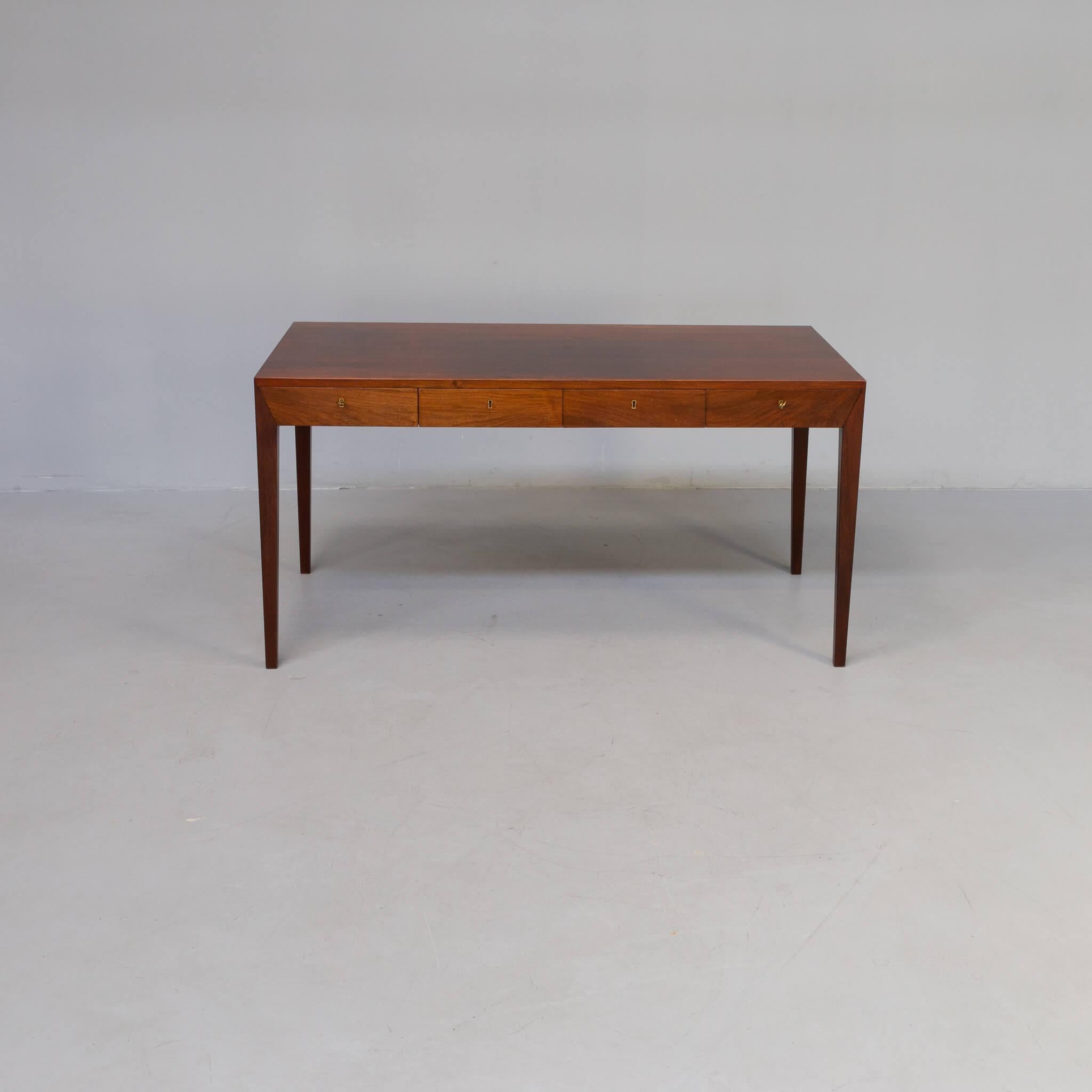 Simplicity and an angular silhouette make this rosewood desk a striking mid-century collectible. It has four elegant drawers and four long tapered legs. Produced by the renowned Danish manufacturer Haslev, this model is one of Severin Hansen’s most
