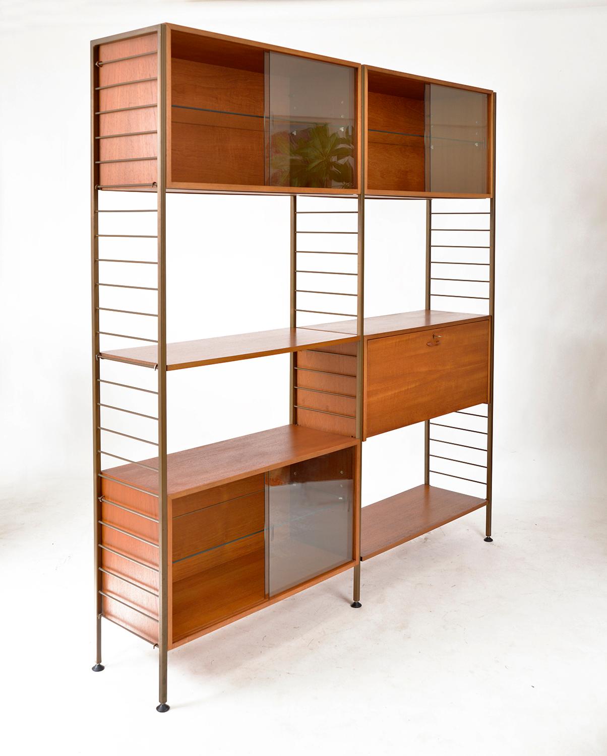 Double bay freestanding 1960s Ladderax shelving system in exceptional condition, having been well cared for over the years. Consisting of three teak boxes with adjustable glass shelves and glass sliding doors, one drop down bureau, and two shelves.