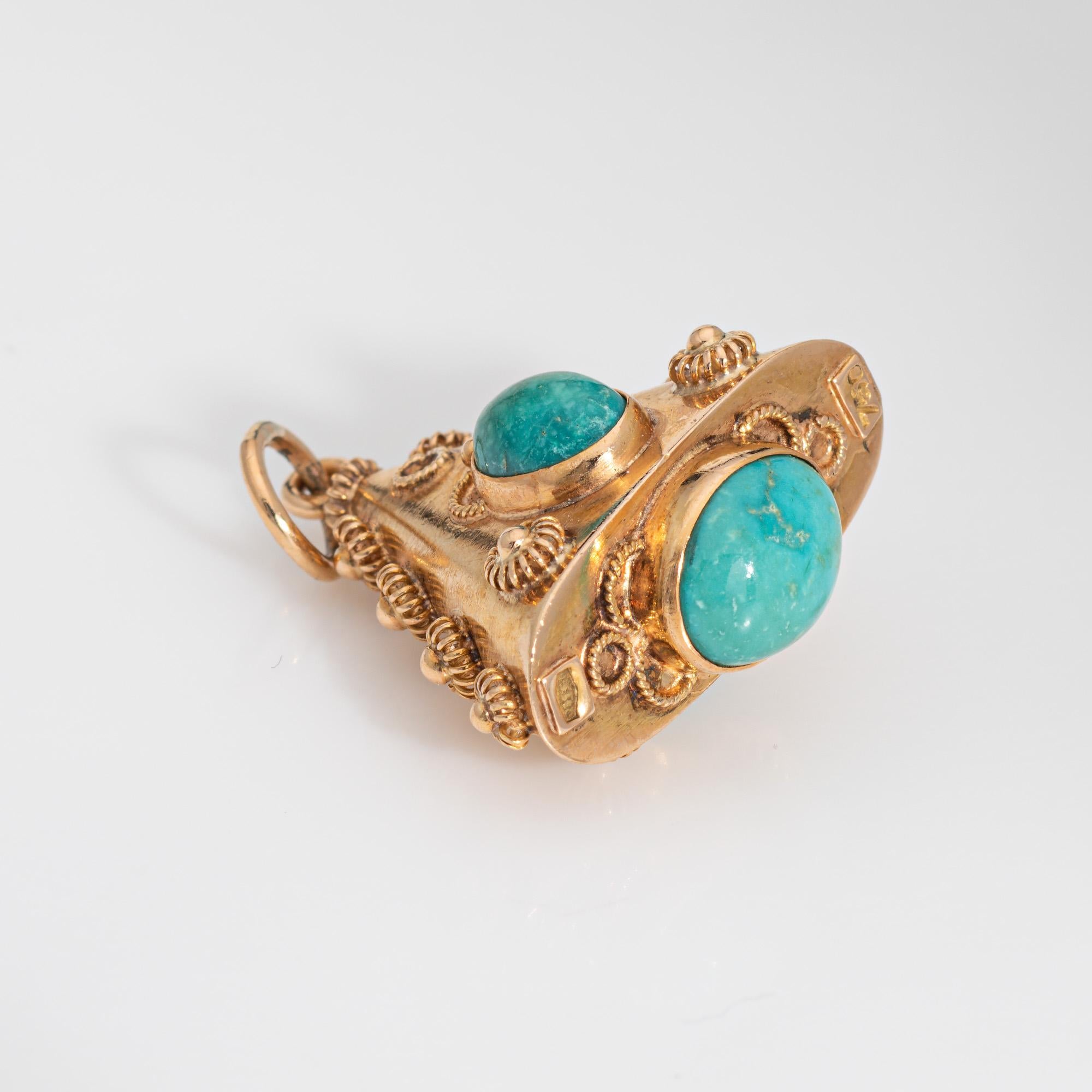 Finely detailed vintage turquoise charm crafted in 18k yellow gold (circa 1960s).  

Three cabochon cut pieces of turquoise measure 10mm x 8mm and 7mm x 5.5mm. The turquoise is in good condition and free of cracks or chips. 

The sweet charm