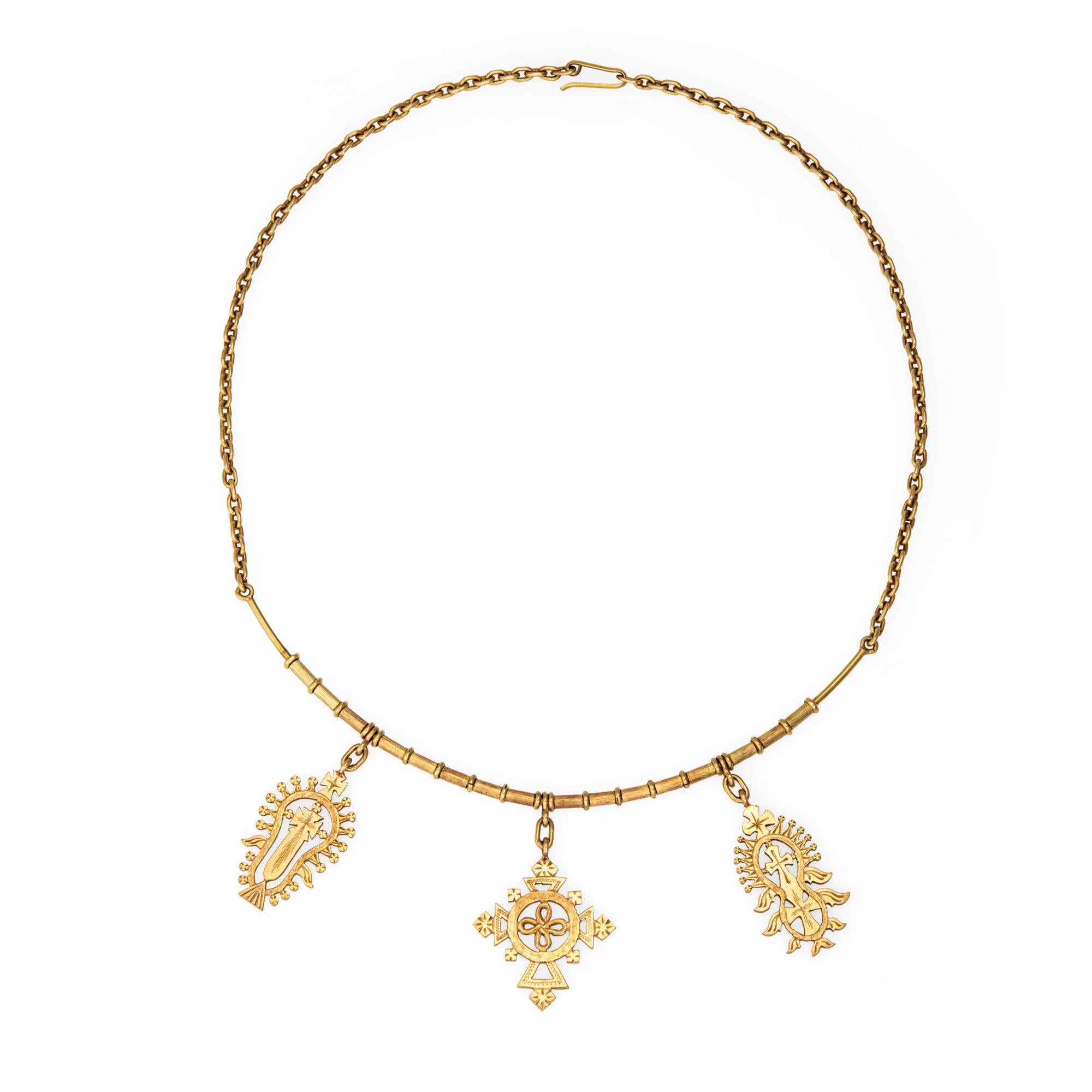 Finely detailed vintage collar medallion necklace crafted in 18 karat yellow gold (circa 1960s).  

The distinct and charming necklace features three large medallions of various designs attached to a semi collar. Measuring 15 1/2 inches the necklace