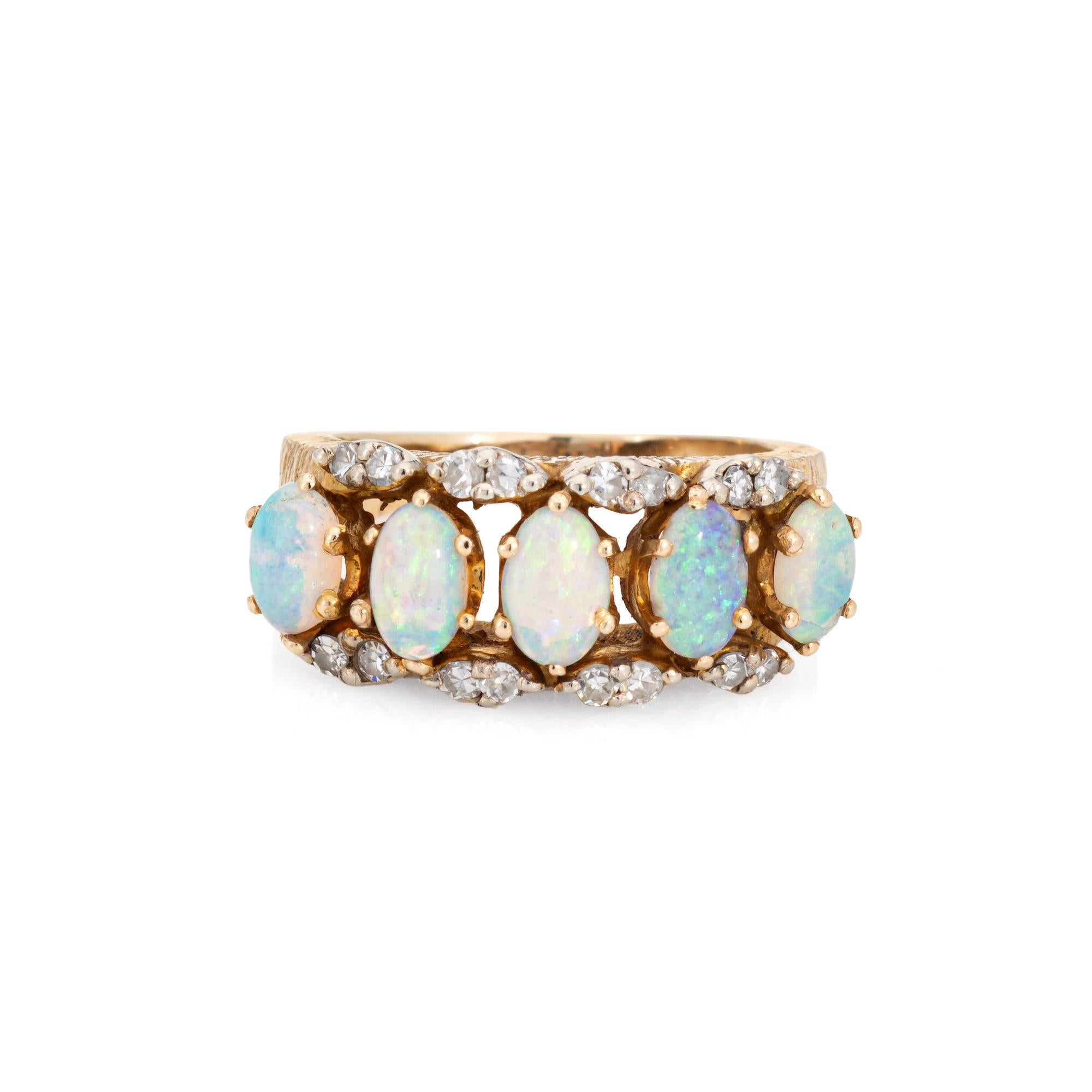 Stylish and finely detailed opal & diamond ring crafted in 14 karat yellow gold (circa 1960s).

Cabochon cut opals measure 5mm x 3mm. 16 single cut diamonds total an estimated 0.08 carats (estimated at H-I color and VS2-I1 clarity). Note: few chips