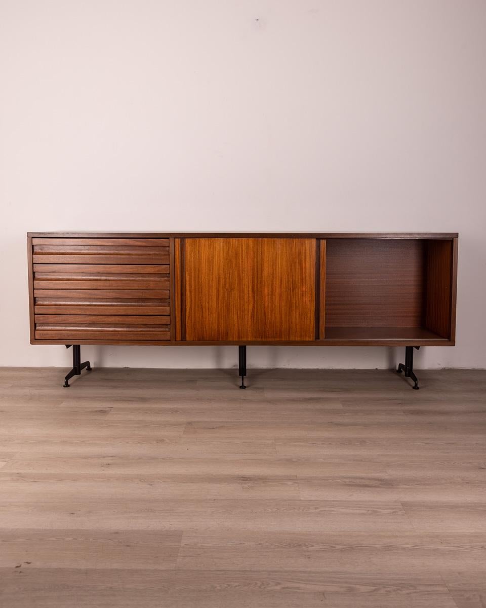Teak wood sideboard with chest of drawers on the left side and two sliding doors on the right side, black steel legs, SE3 model, design Osvaldo Borsani for Tecno, 60s.

CONDITIONS: In good condition, it may show signs of wear given by