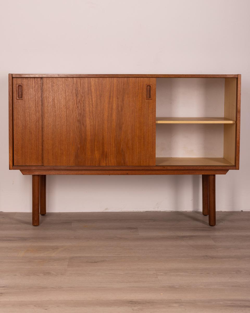 Sideboard in teak wood, has two sliding doors, Danish design, 1960s.

CONDITIONS: in good condition, it may show signs of wear given by time.

DIMENSIONS: height 80 cm; width 120 cm; length 40 cm

MATERIALS: wood

YEAR OF PRODUCTION: circa