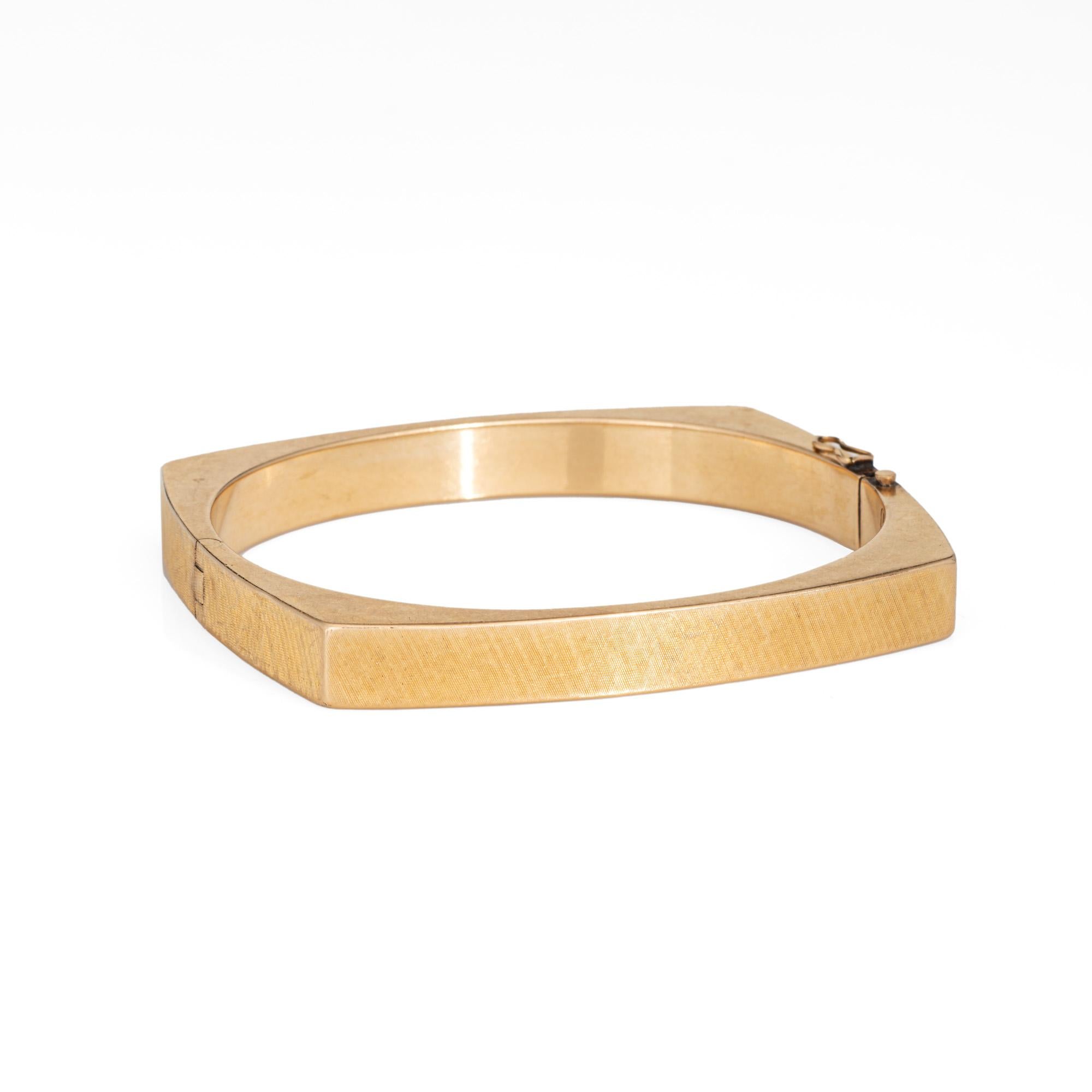Stylish vintage square bangle bracelet crafted in 14 karat yellow gold (circa 1960s to 1970s). 

Graceful in design, the square bangle bracelet makes a statement and is great worn alone or as a part of a bracelet stack. Measuring 7.5mm wide (0.29