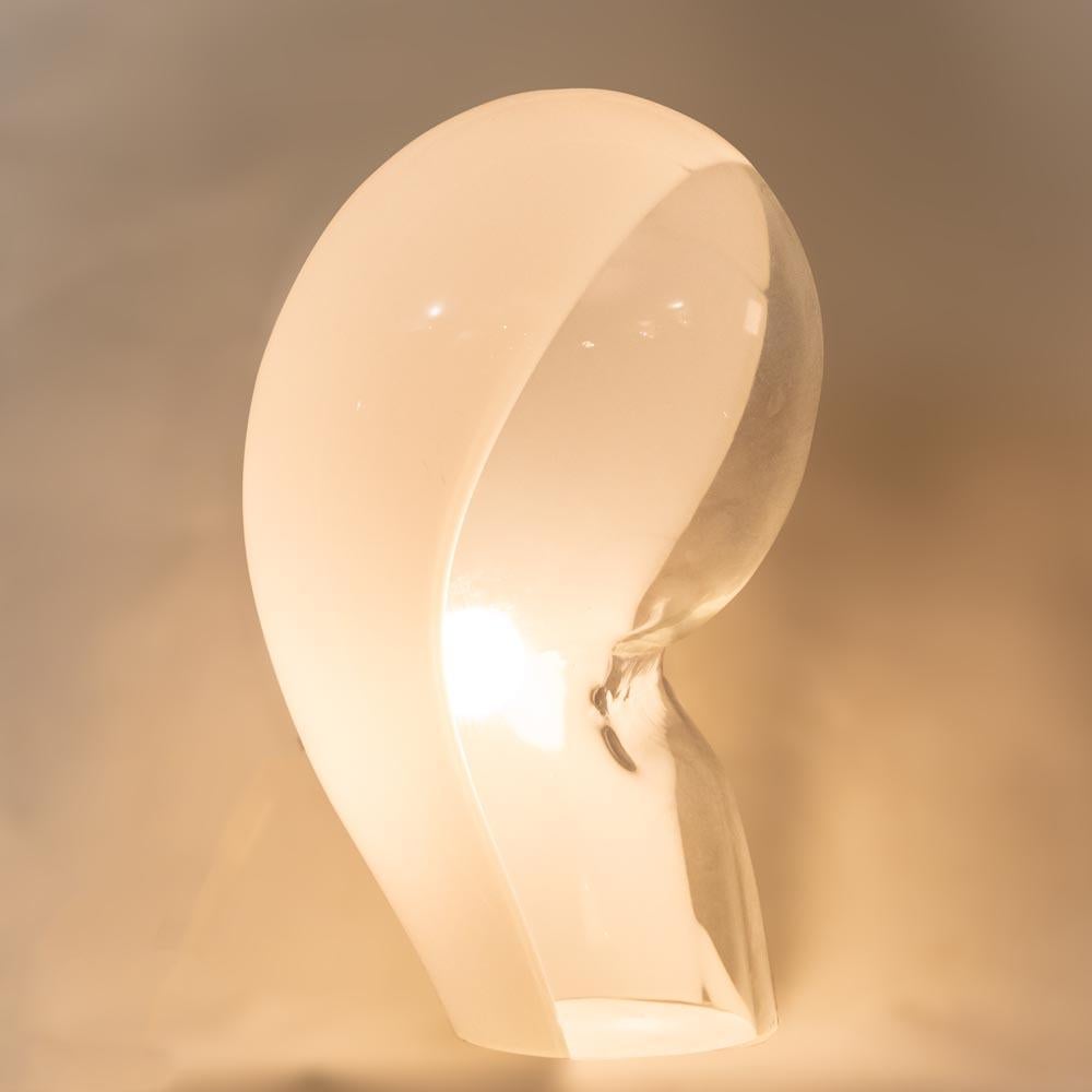 This original vintage table light was created by Vetreria Vistosi and produced by Vistosi brand back in the 60s Space Age in their Murano furnace in Italy.
The soft, round, curvilinear lines of this lamp make it easy to arrange and move around in