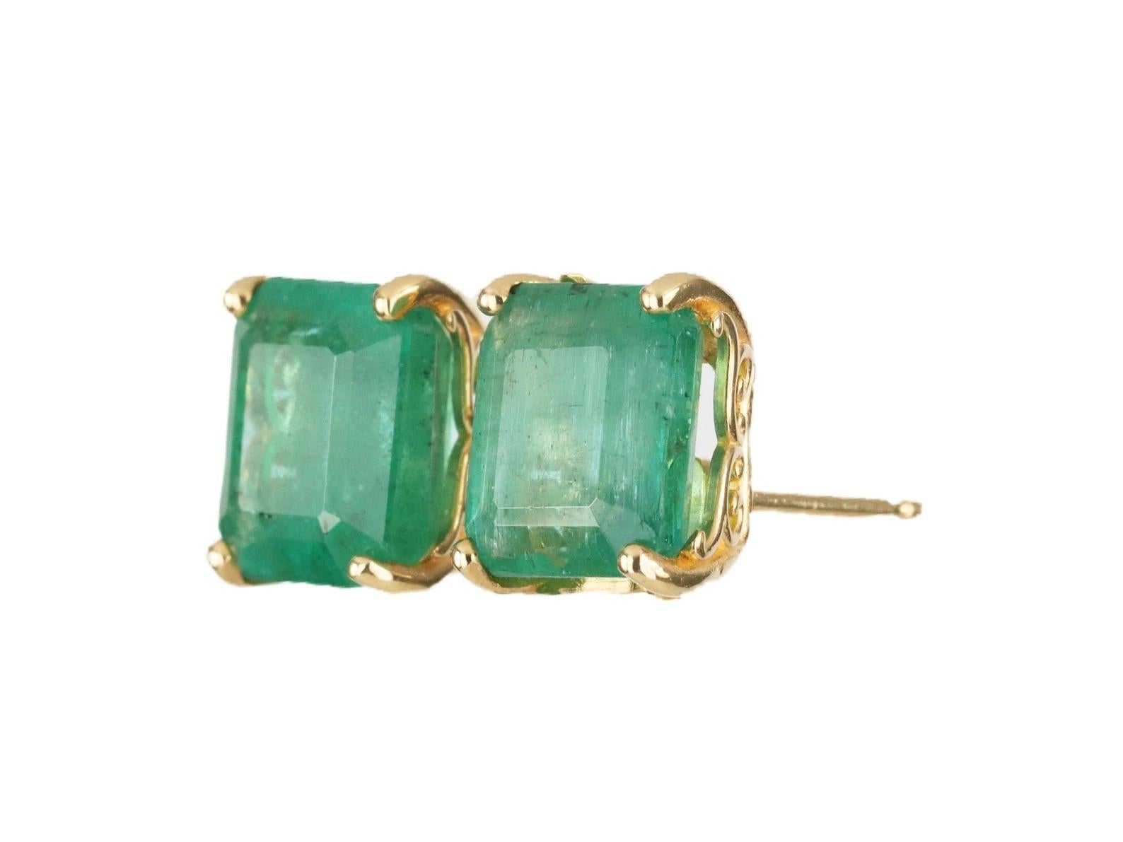 Featured here is a beautiful set of emerald cut- emerald studs in fine 14K yellow gold. Displayed are medium-green emeralds with good transparency, accented by a simple four-prong 14K gold mount, allowing for the emerald to be shown in full view.