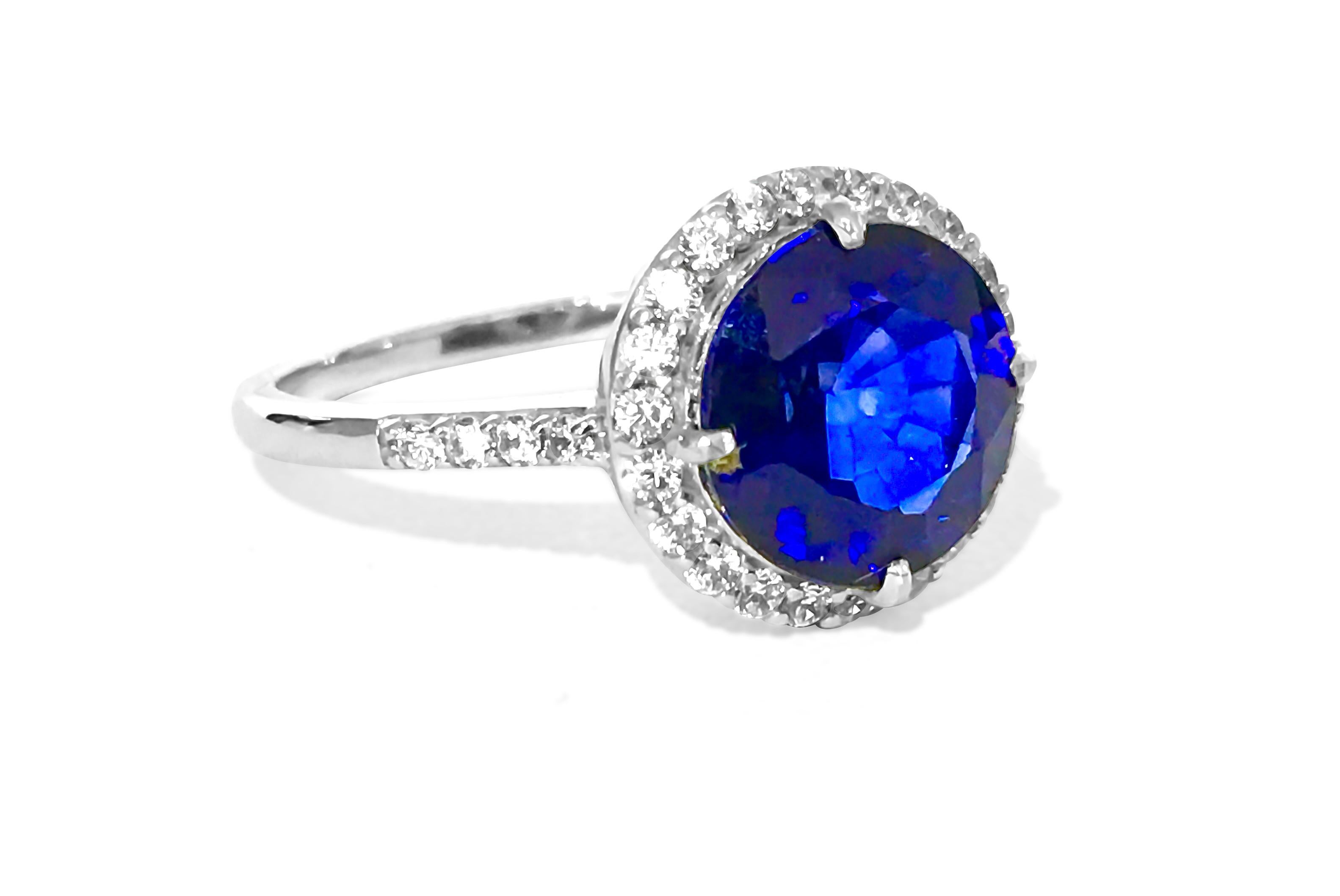 Solid 10k white gold. 
5.50 carat blue sapphire, round cut. 100% natural earth mined blue sapphire. 
0.60 carat diamonds. VS-SI clarity and G color. Round brilliant cut diamonds. 100% natural earth mined diamonds.
Total carat weight: 6.10 carats
All