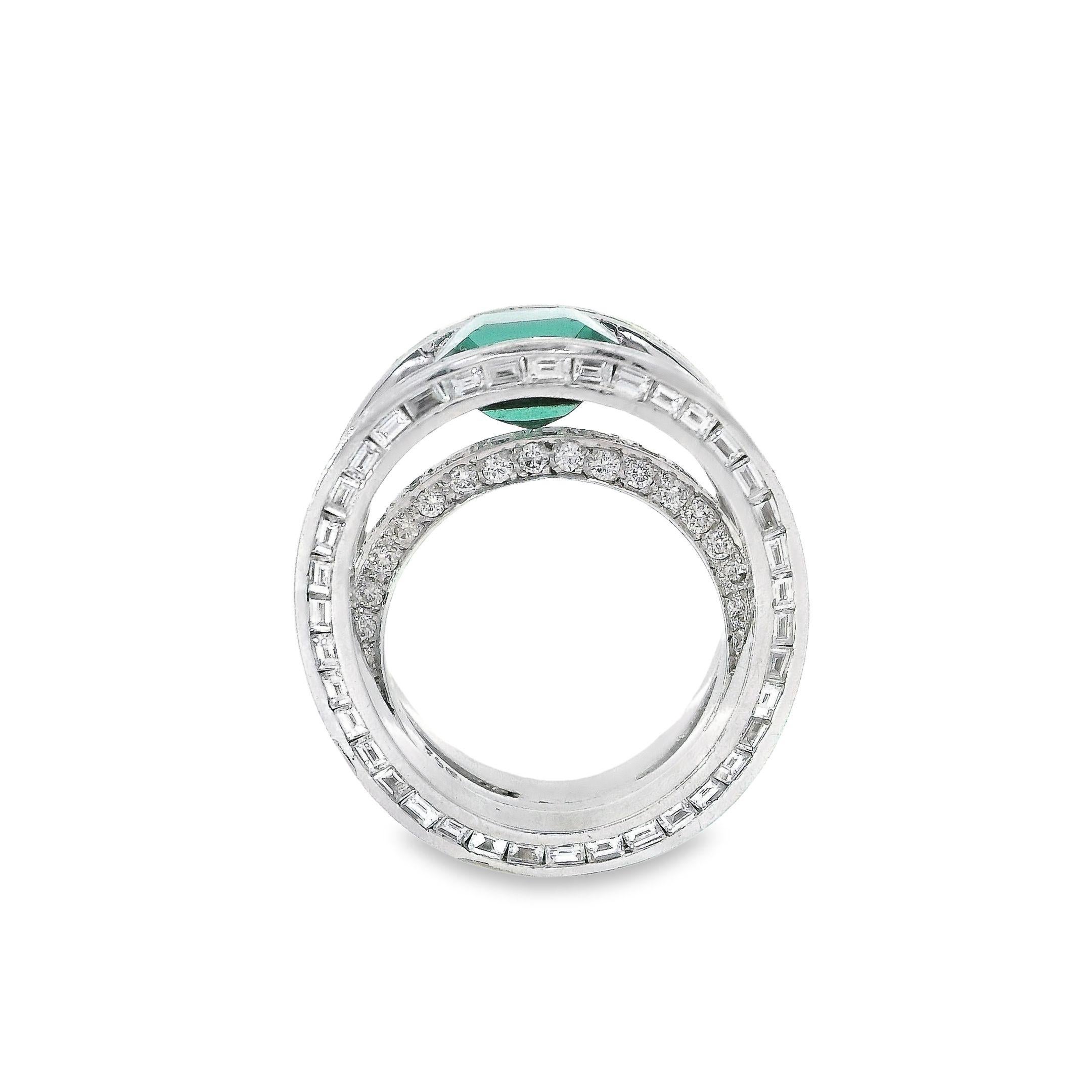 This graceful ring emanates an aura of effortless sophistication. At its center lies a vibrant green tourmaline of extraordinary depth and clarity, its emerald cut exhibiting six pristine facets that magnify its natural splendor to brilliant effect.
