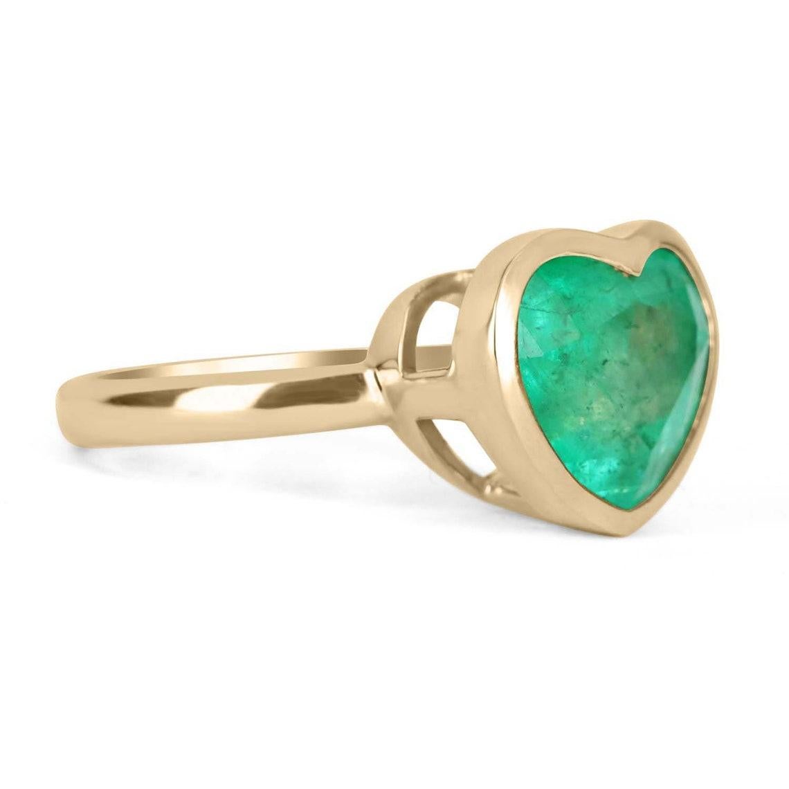 This ring is not for the faint of heart! Displayed is a VERY large Colombian emerald heart solitaire ring in 14K gold. This gorgeous solitaire ring is bezel set in yellow gold and carries a full 6.10-carat emerald that will have you gazing at its