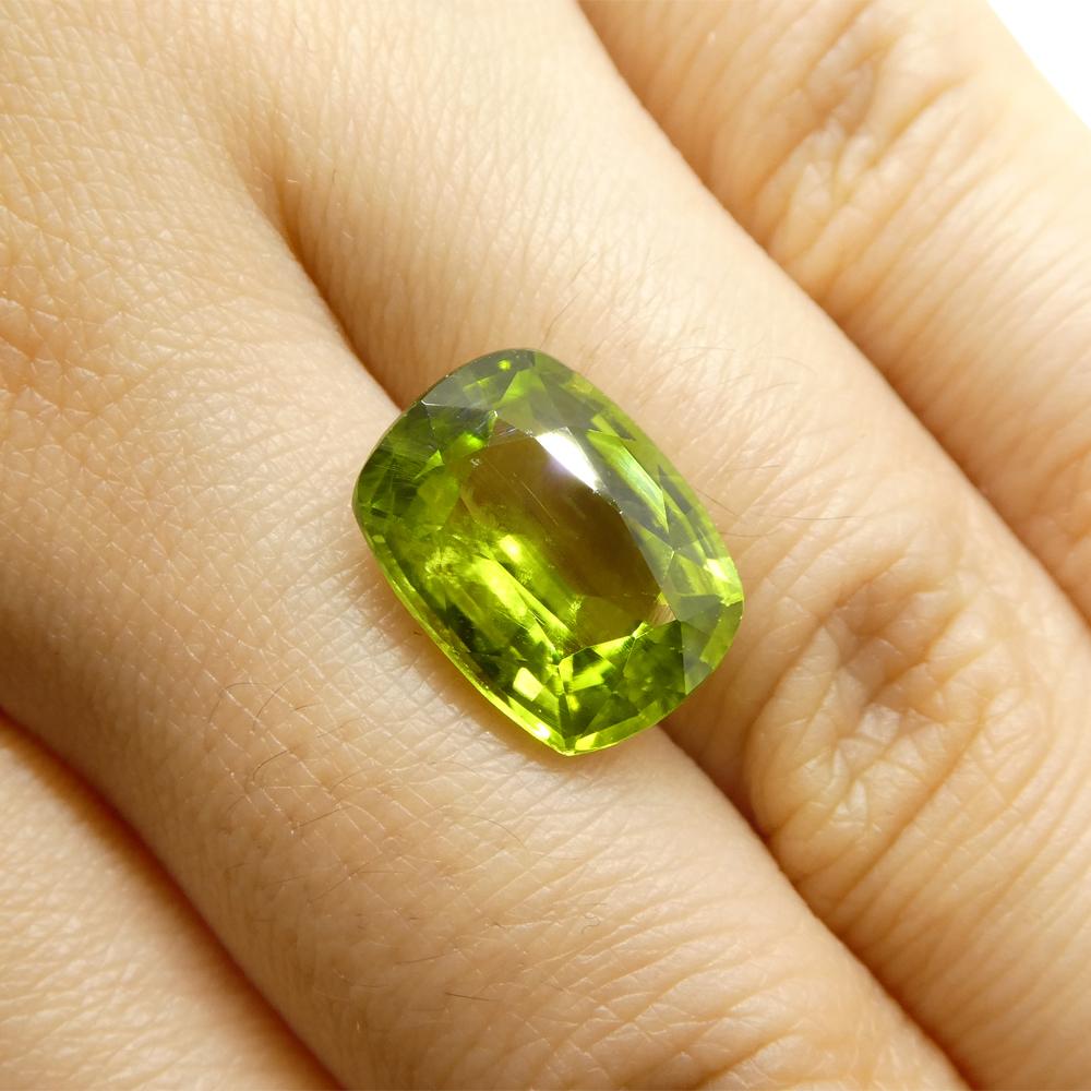 Description:

Gem Type: Peridot
Number of Stones: 1
Weight: 6.11 cts
Measurements: 13.07 x 9.85 x 6.16 mm
Shape: Cushion
Cutting Style Crown: Brilliant Cut
Cutting Style Pavilion: Step Cut
Transparency: Transparent
Clarity: Very Slightly Included: