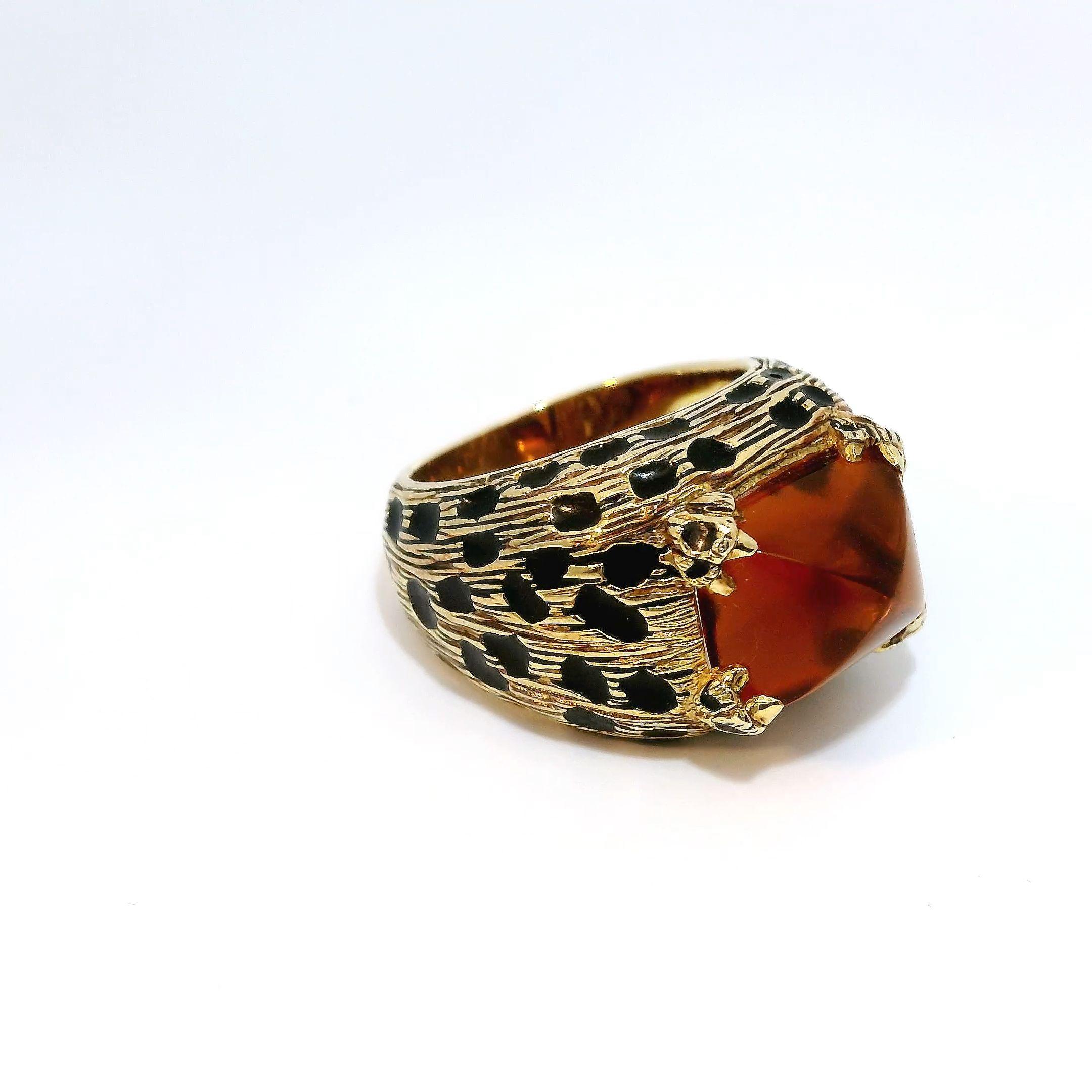The ring features a show-stopping sugarloaf cut Citrine gemstone at its center that has been expertly chosen for its remarkable clarity and warm sunny hue. Measuring over 6 carats in size, this sizable stone is sure to stand out on the finger and